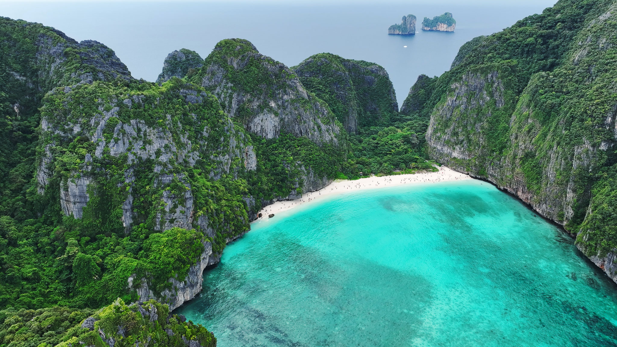 Drone aerial photo of a tropical lagoon surrounded by limestone cliffs and emerald water.