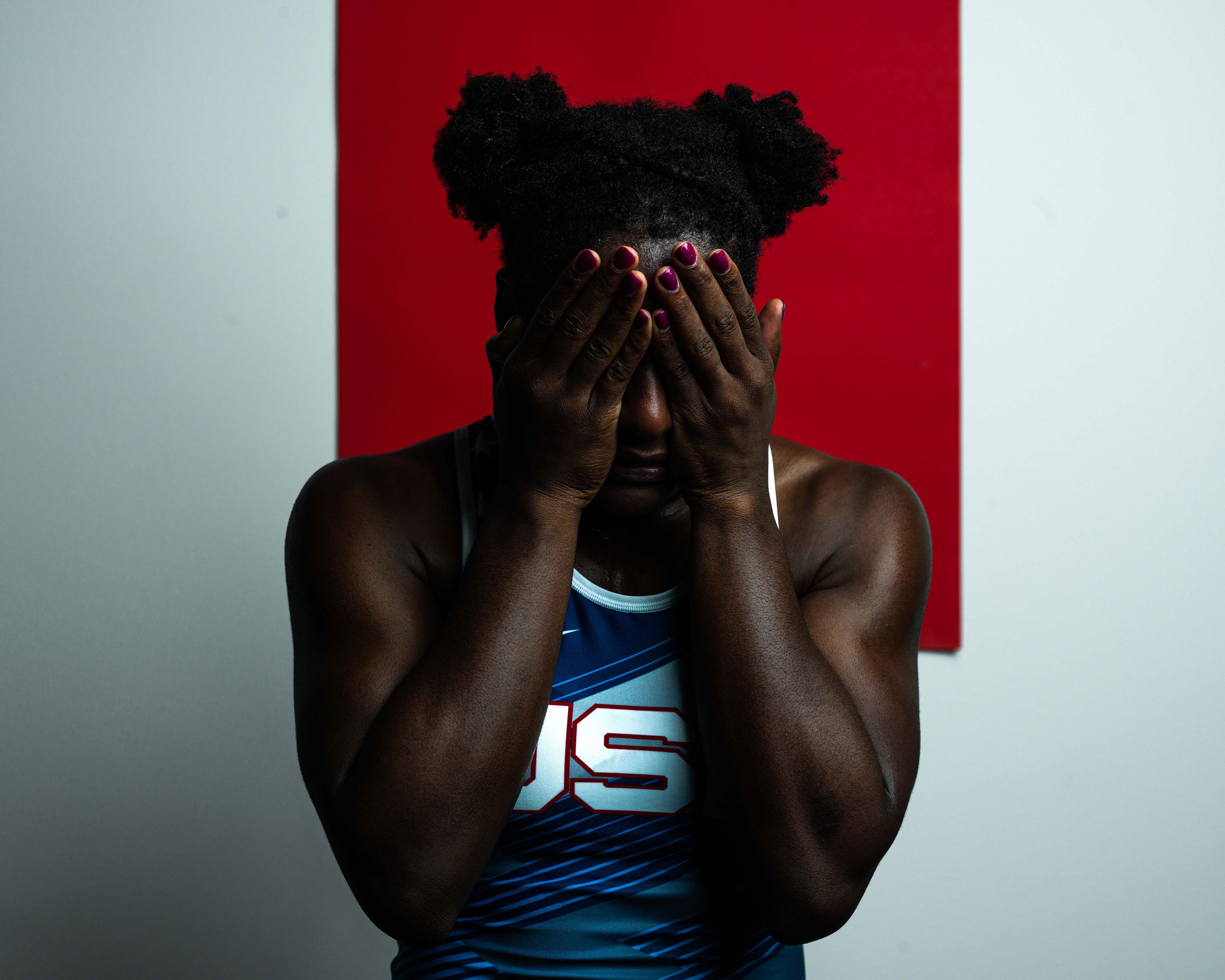 A wrestler with their head in their hands, shot on Phase One P45 Plus by Theo Lowenstein