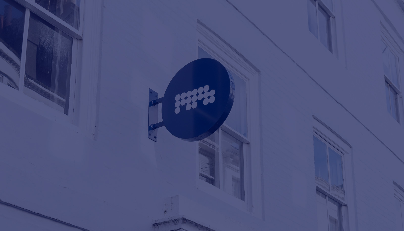 MPB sign on outside of building, blue overlay