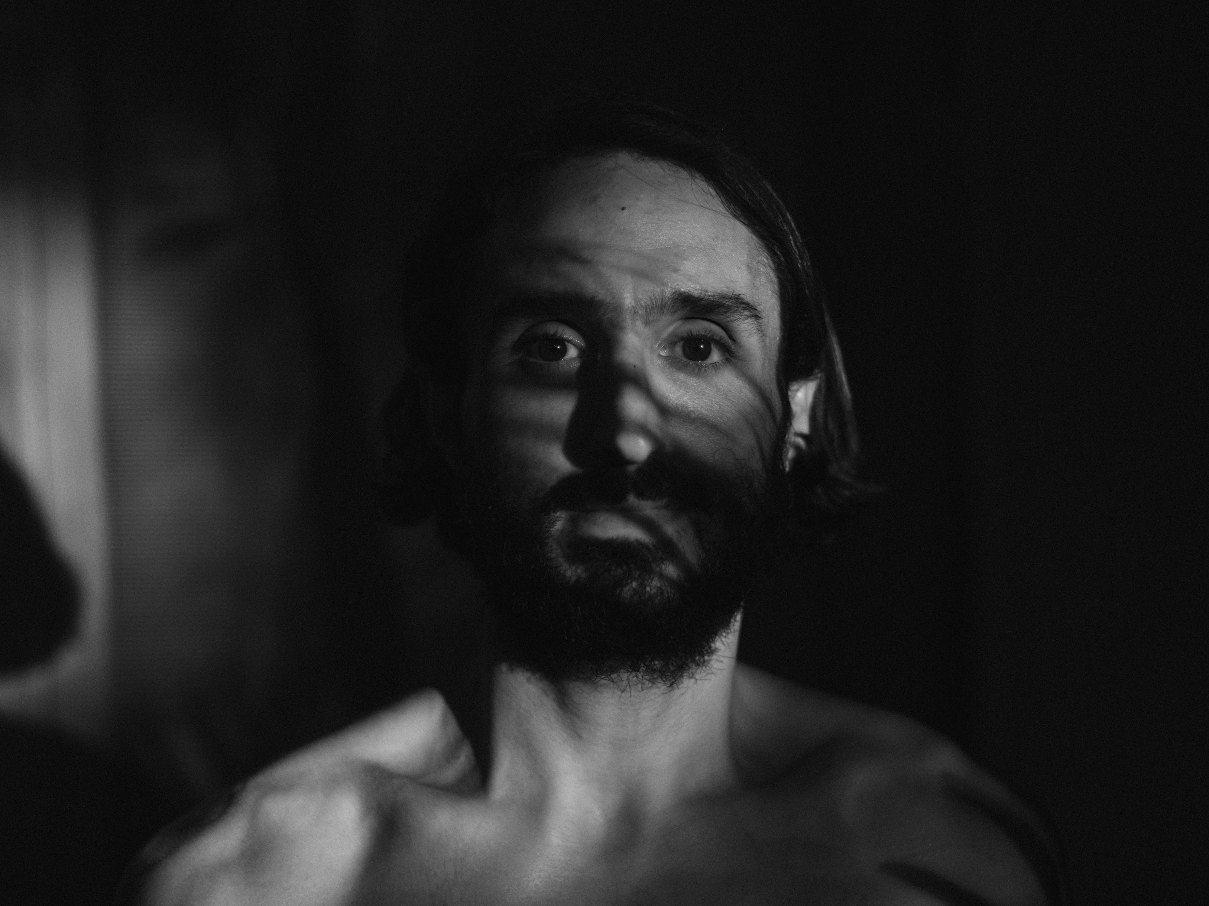 Black and white photo of a man in shadow shot by Ian Howorth with a Hasselblad X1D II medium format camera.