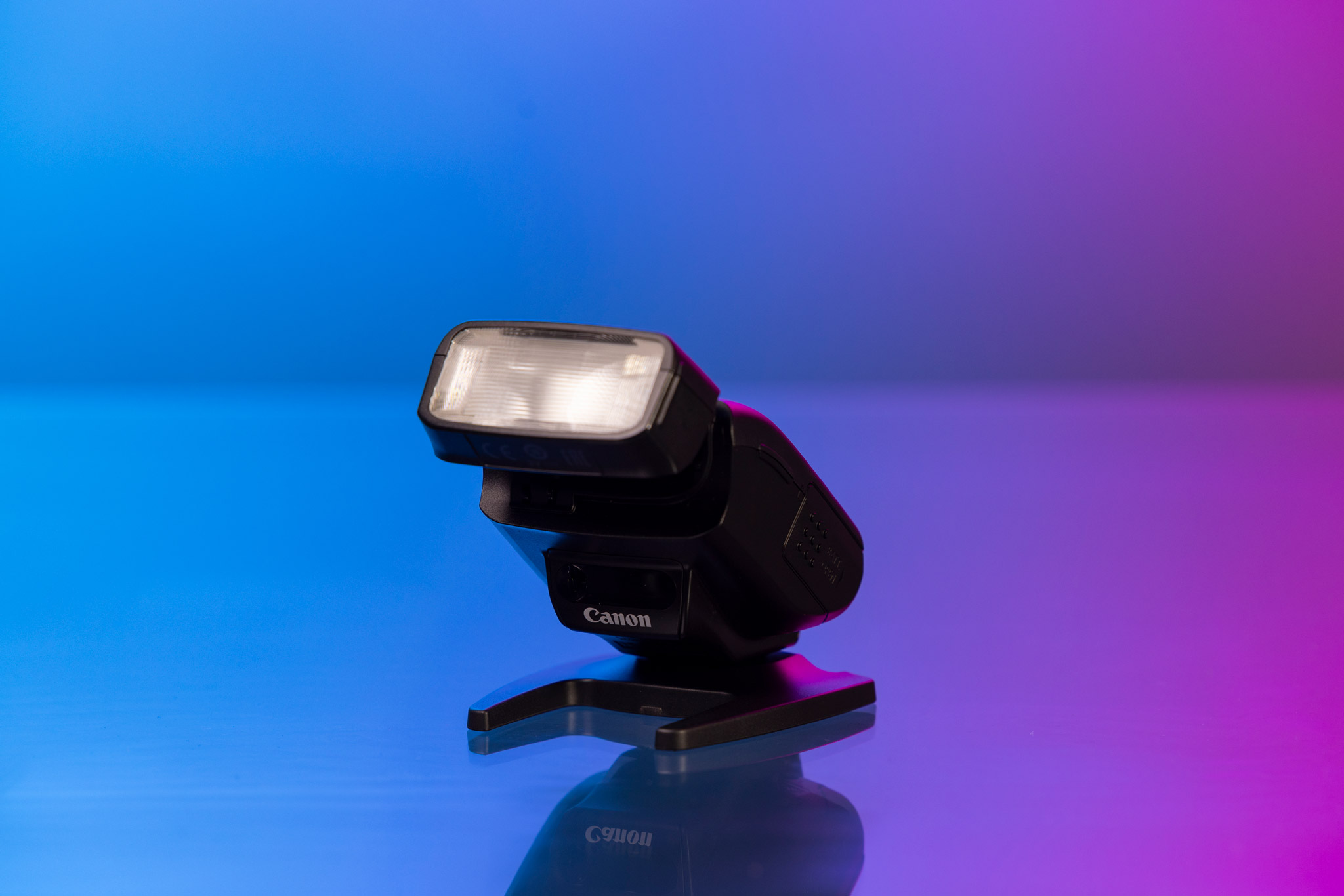 Canon Speedlite 270EX II posé devant un fond bleu et violet.