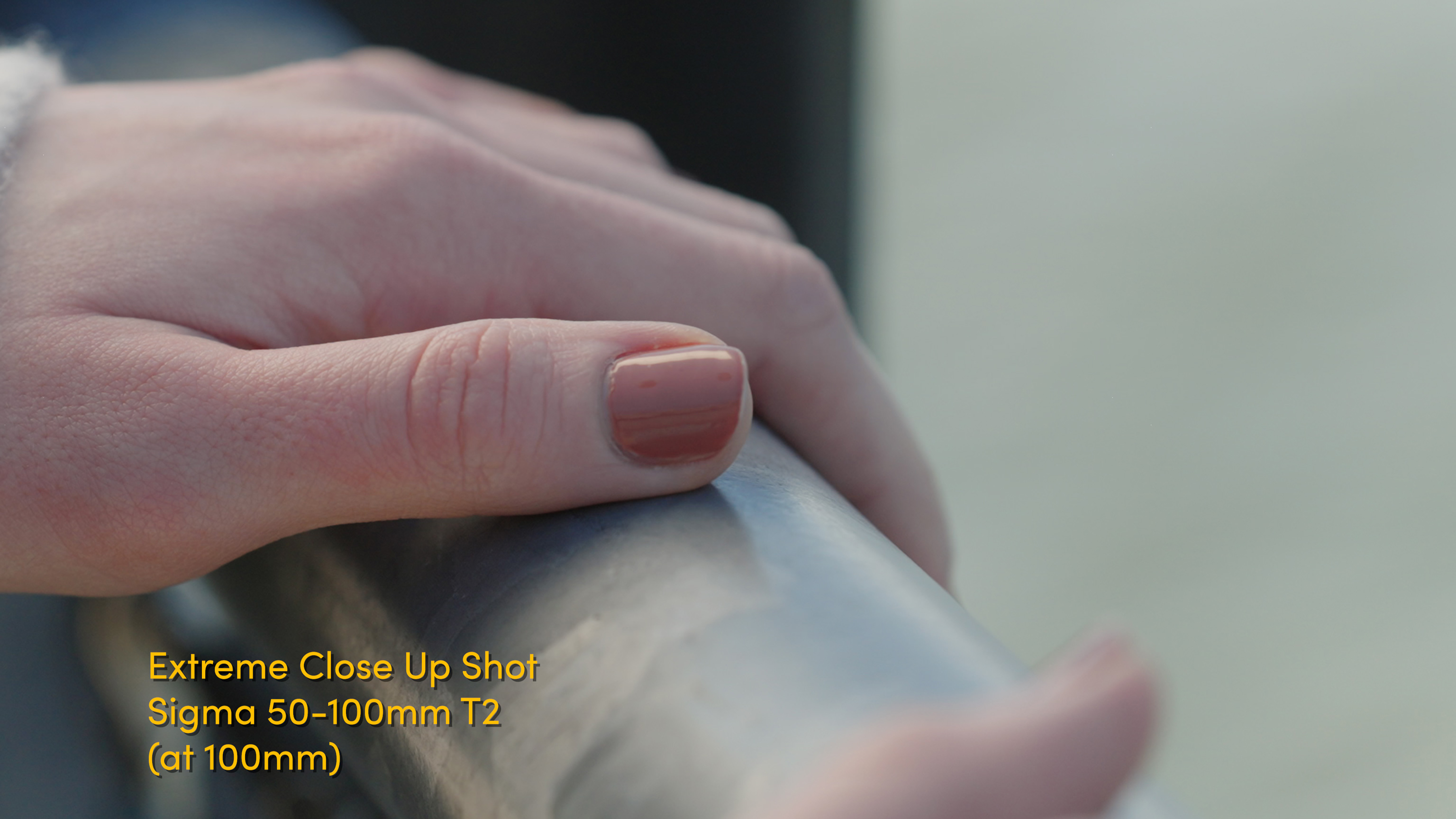 Example of an extreme close up shot with persons hands holding metal bar