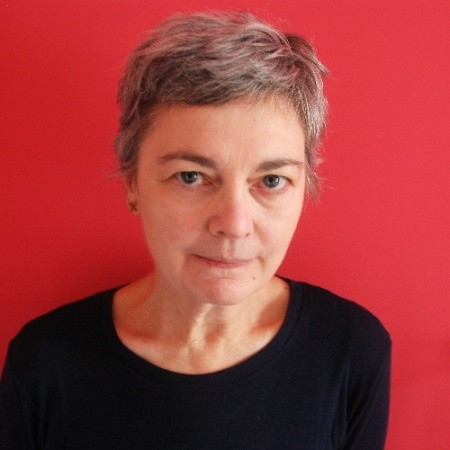 A portrait photo of Sian Bonnell wearing a black top against a red background