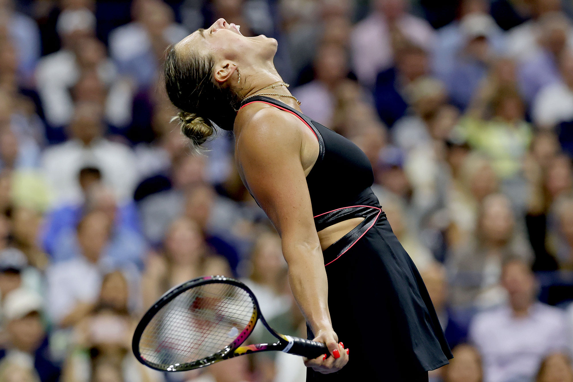 Aryna Sabalenka celebrates a match point against Jessica Pegula of the United States during their Women's Singles Semifinal match of the 2025 US Open at USTA Billie Jean King National Tennis Center in New York City. She is screaming up at the air, with her racquet in her right hand.