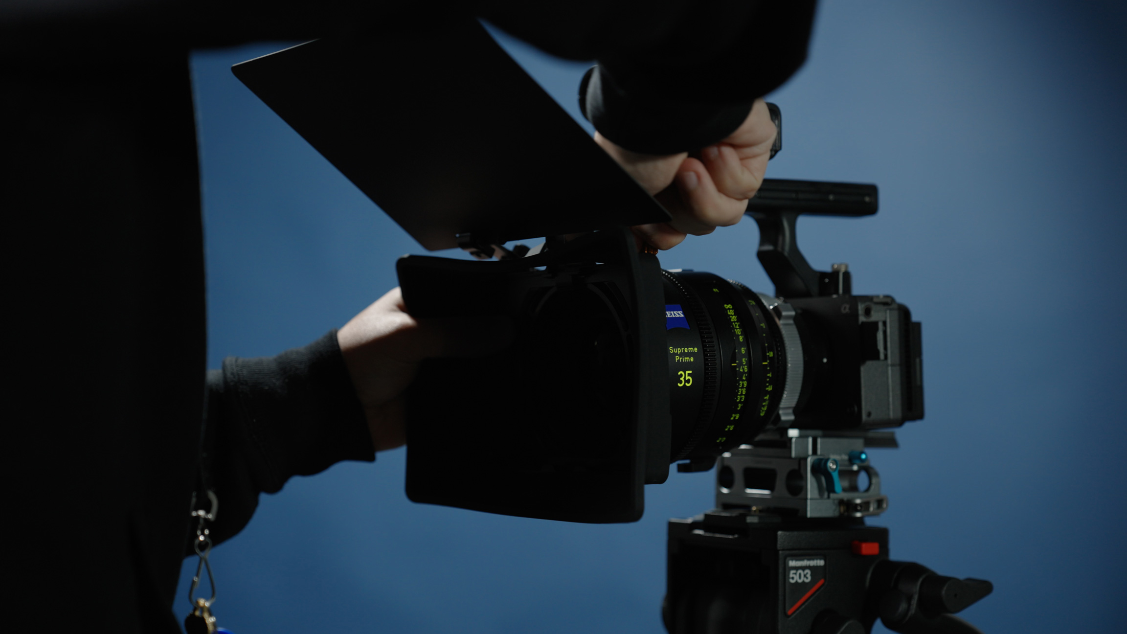 Photo of Sony Fx3 with matte box covering lens in front of blue background