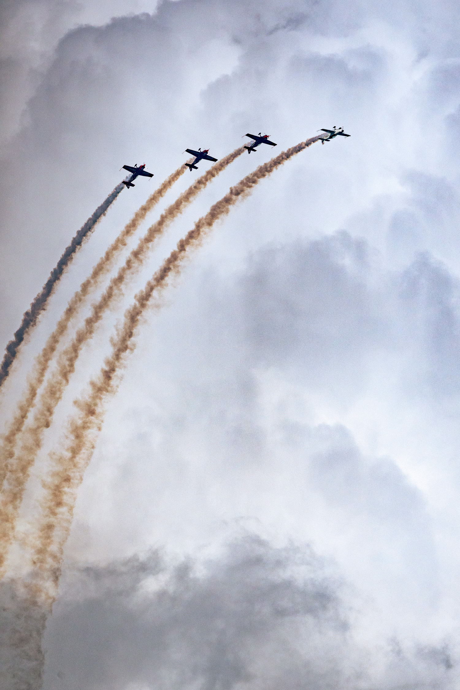 British RAF Red Arrow manoeuvring effects in flight at the Eastbourne International Airshow