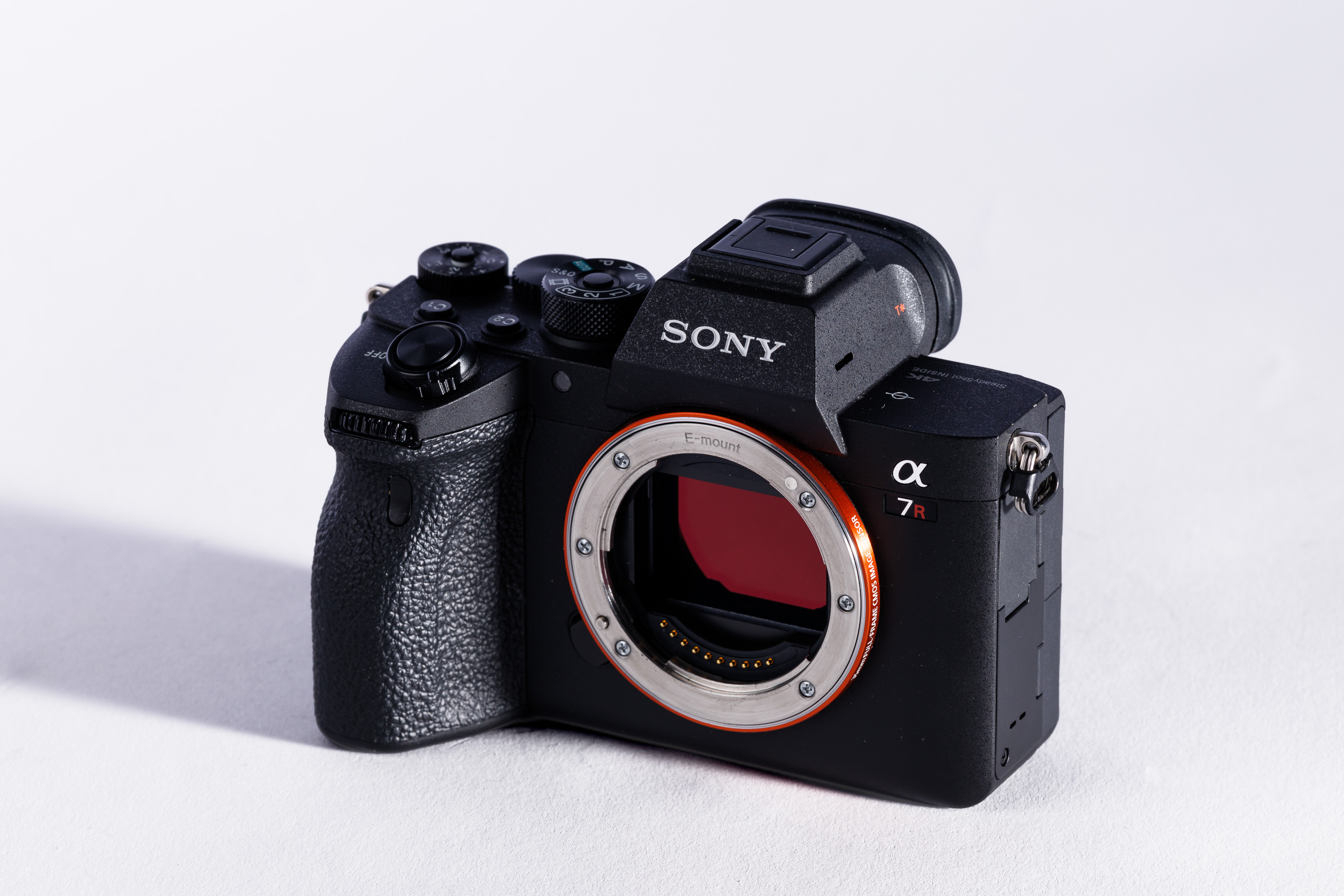A used Sony A7R V on a white background, with a shadow to the left.