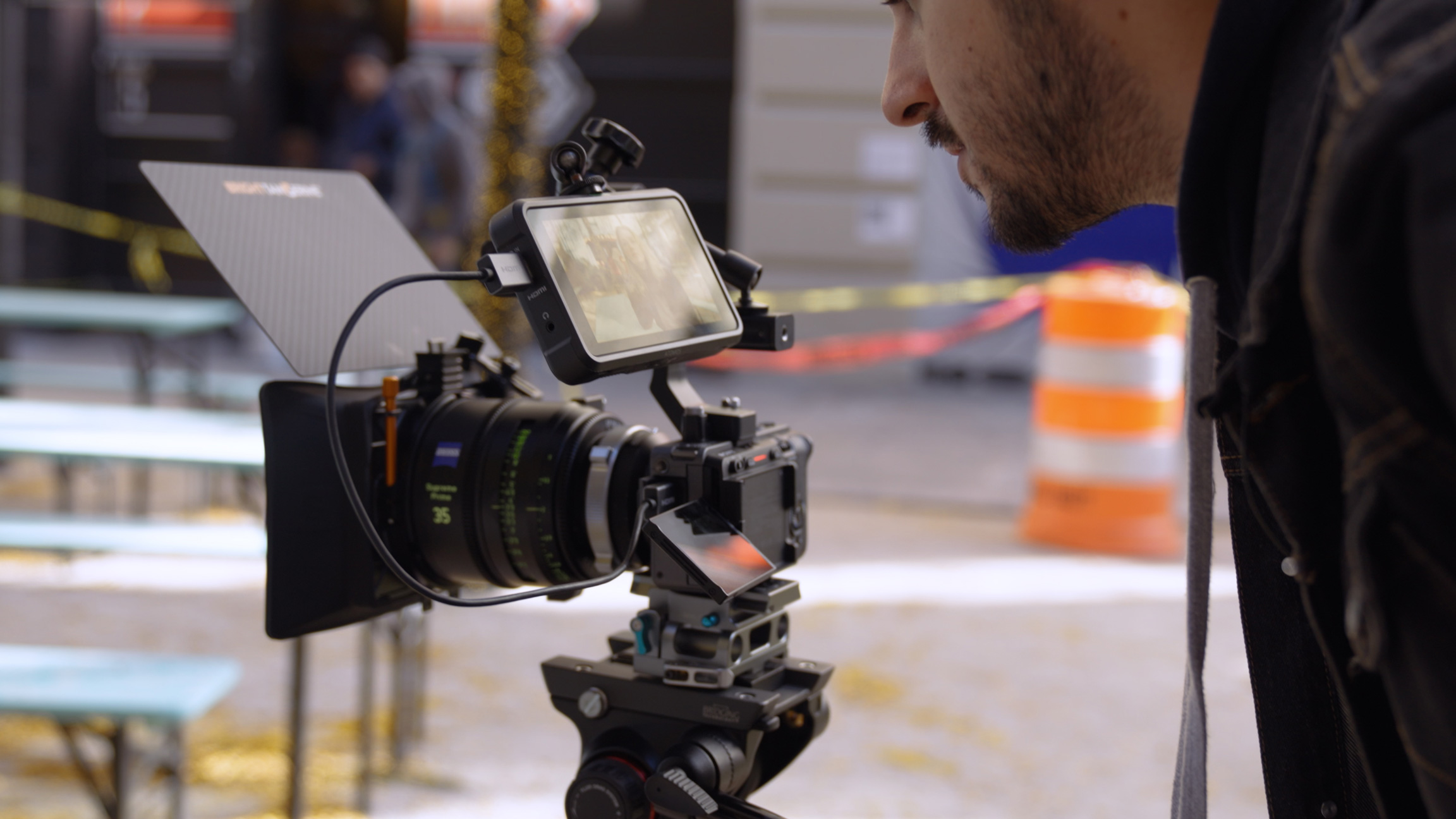 Person looking at camera monitor on top of a Sony Fx3