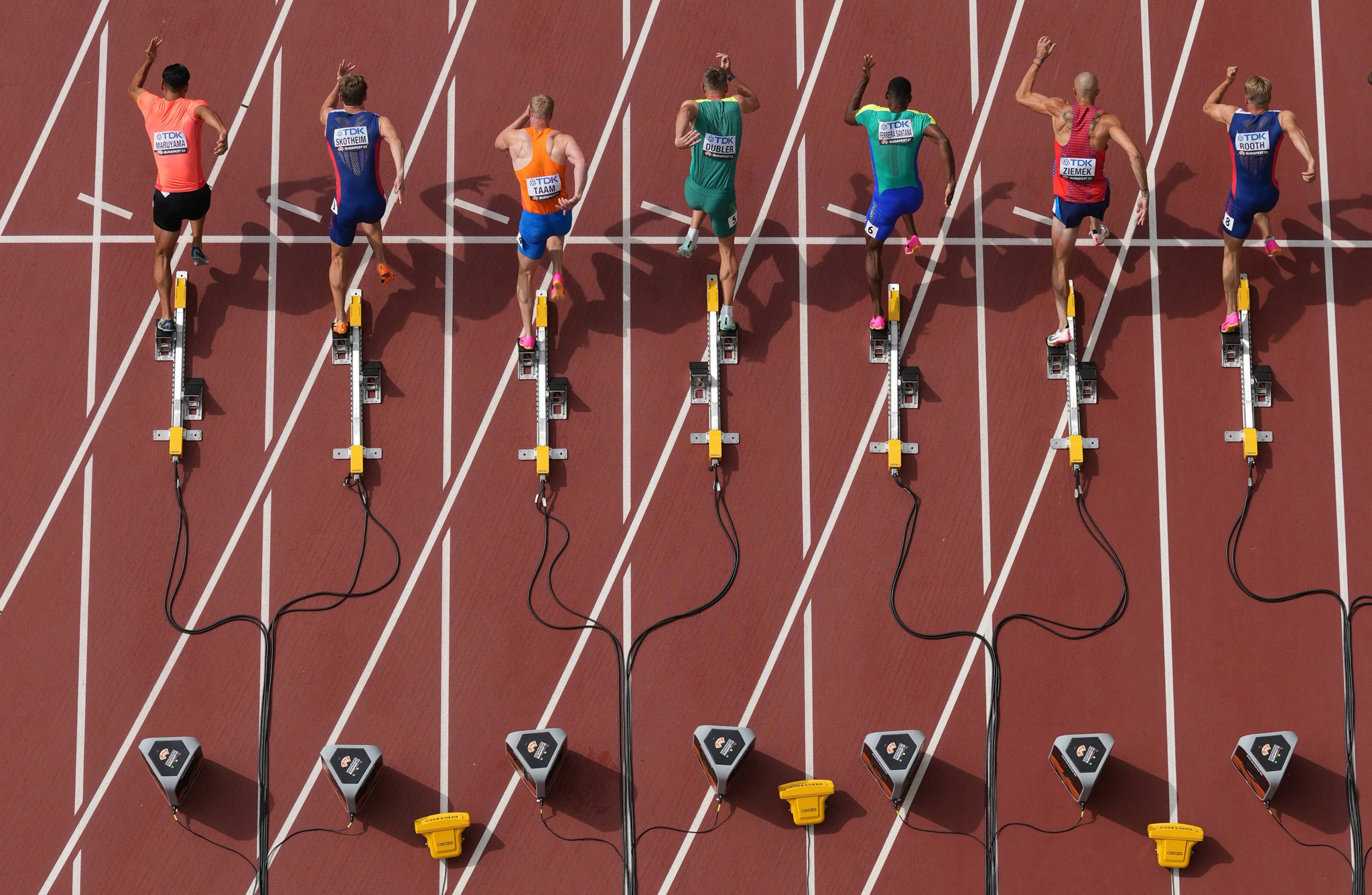A top-down drone shot of the very start of a 100-meter sprint shows each runner's explosive start. By Fabrizio Bensch.