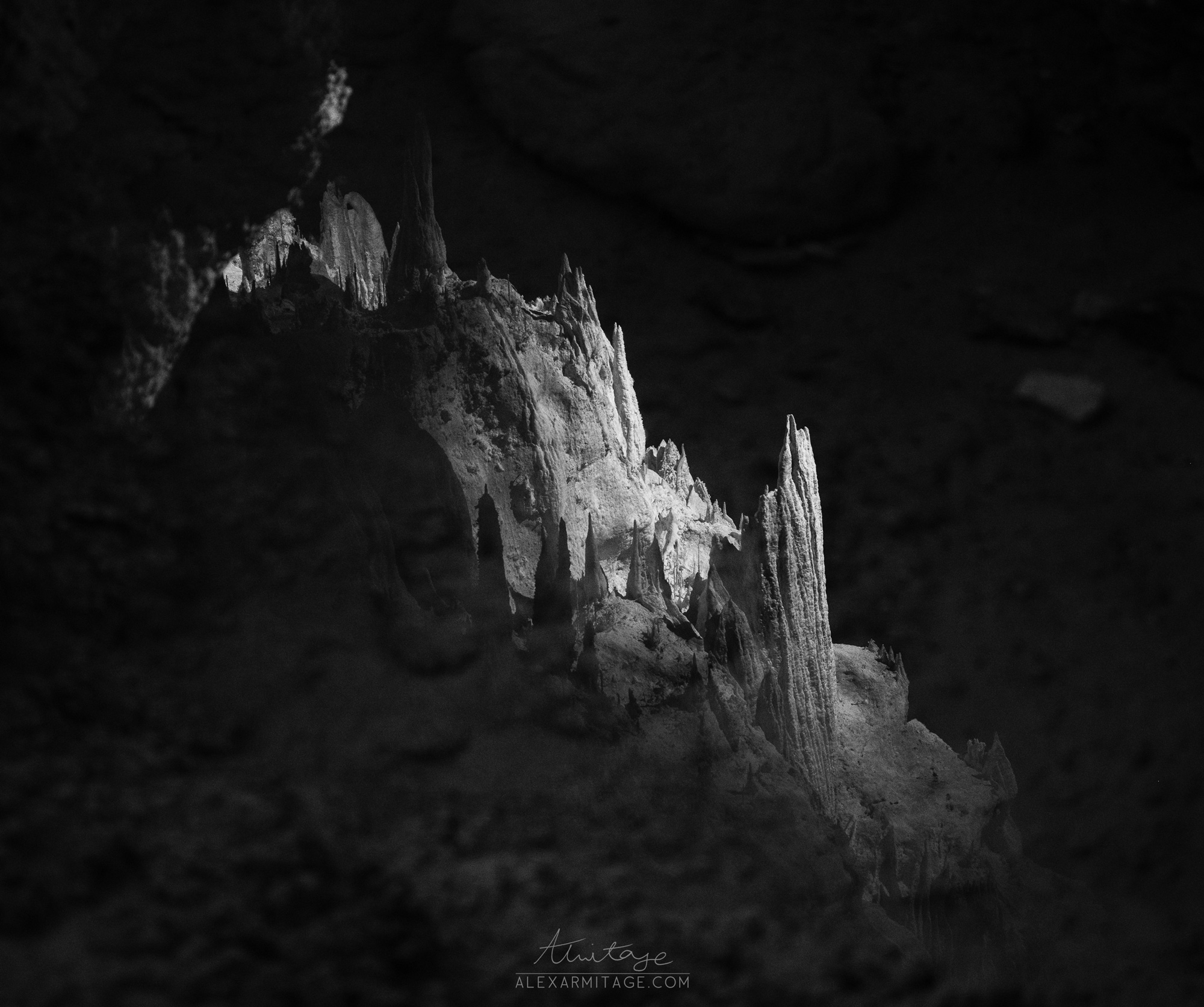 Black and white image of a stalactites in a cave in New Mexico, taken by Alex Armitage on a Nikon Z8.