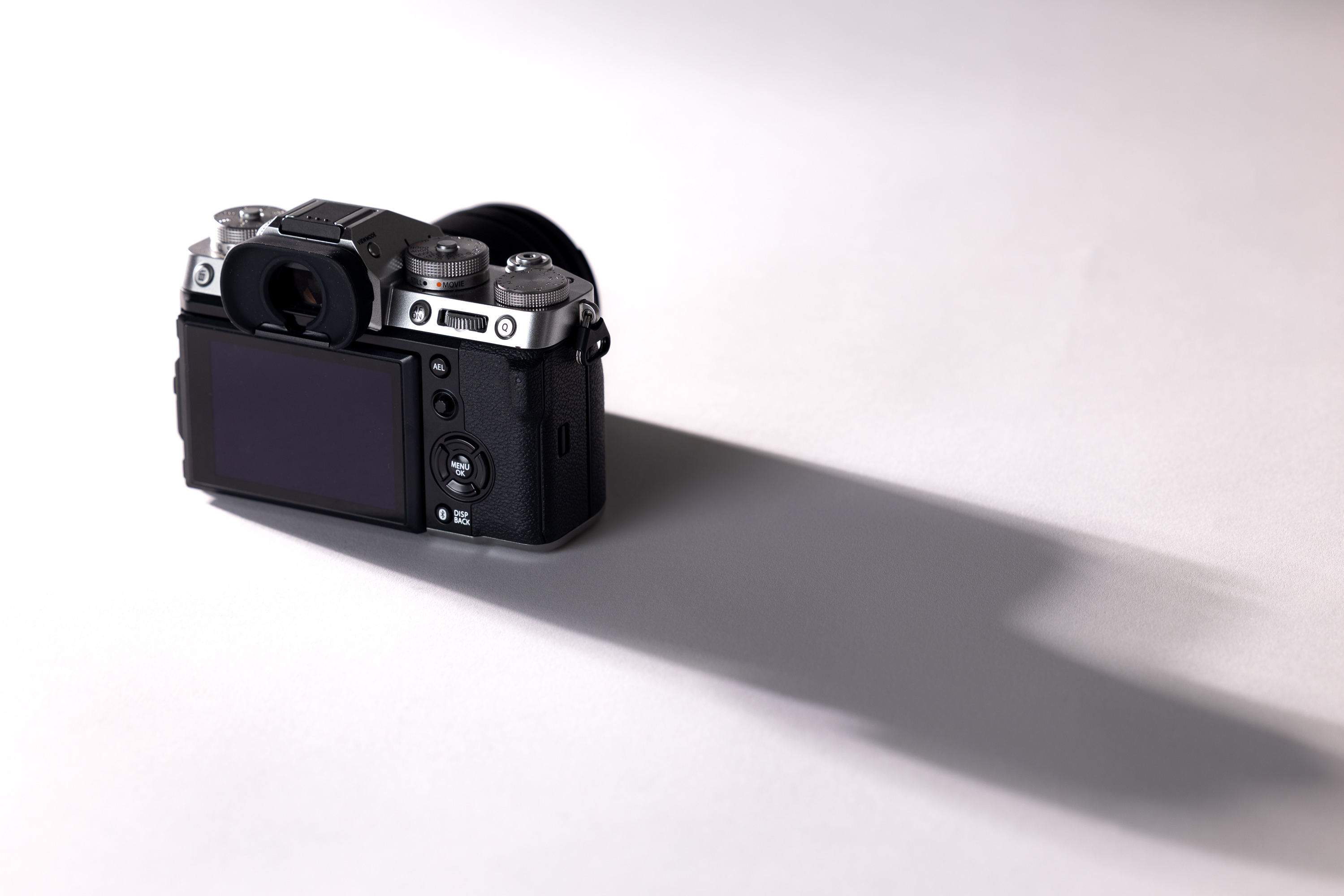 Fujifilm X-T5 on a white background with a long dark shadow 