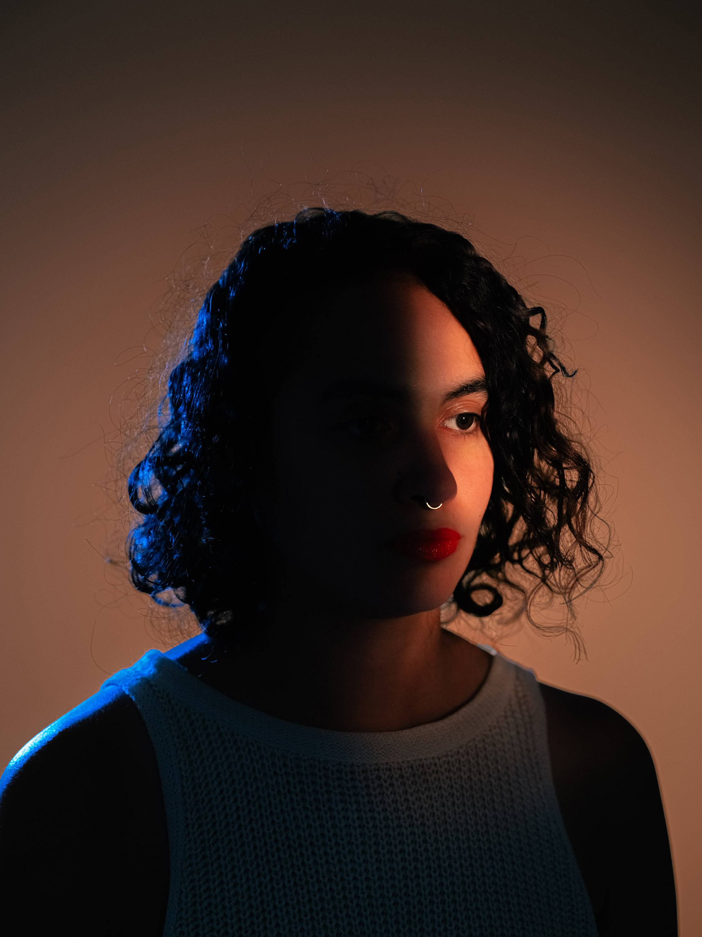 Portrait of a person with half their face in the light