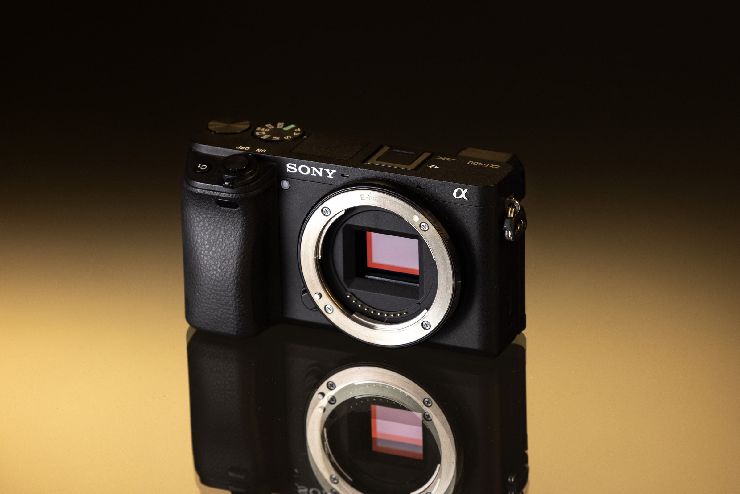 Sony A6400 on a black and gold background.