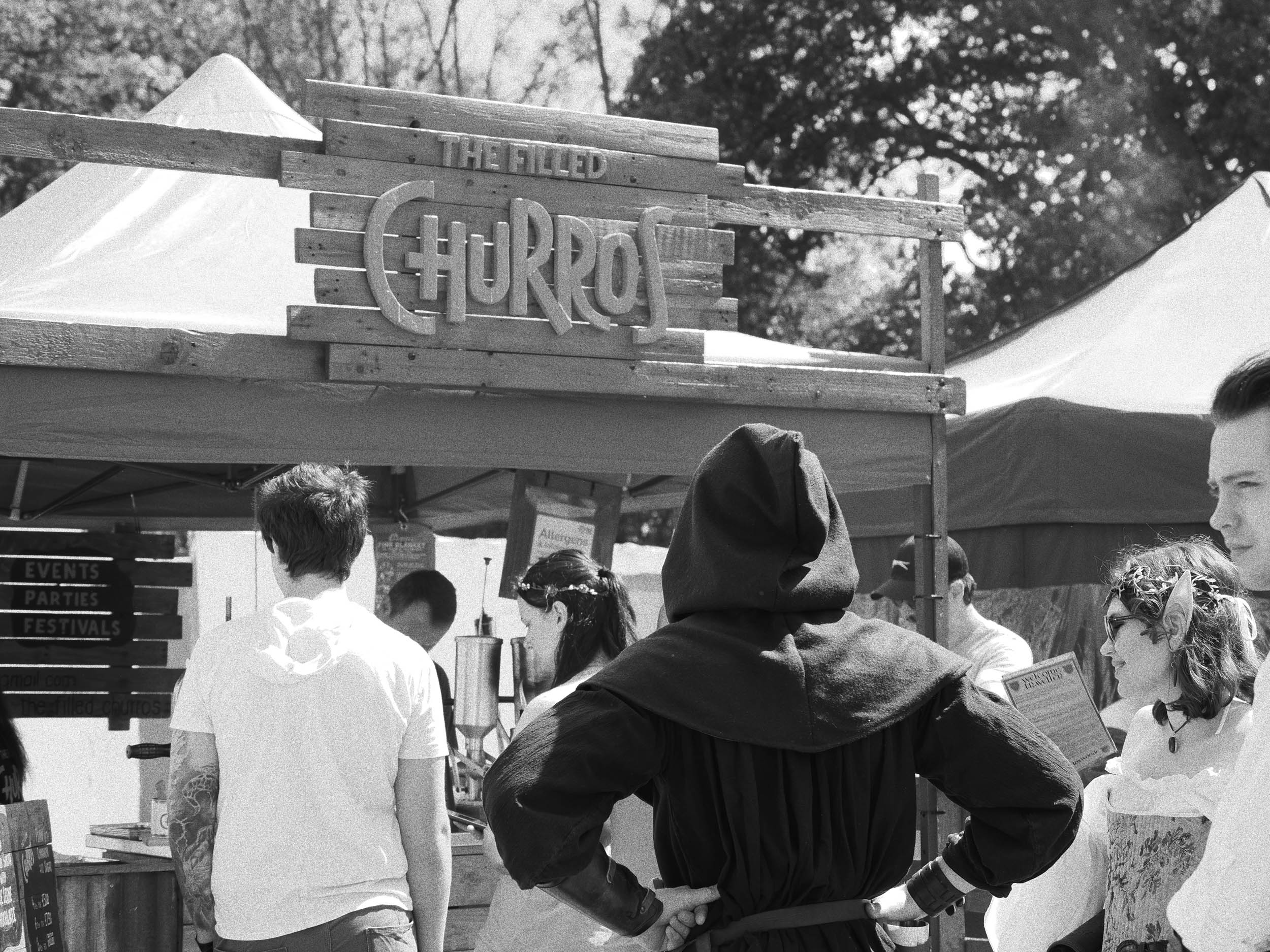 People queuing for churros at a festival, by Jakub Golis with an OM System OM-3