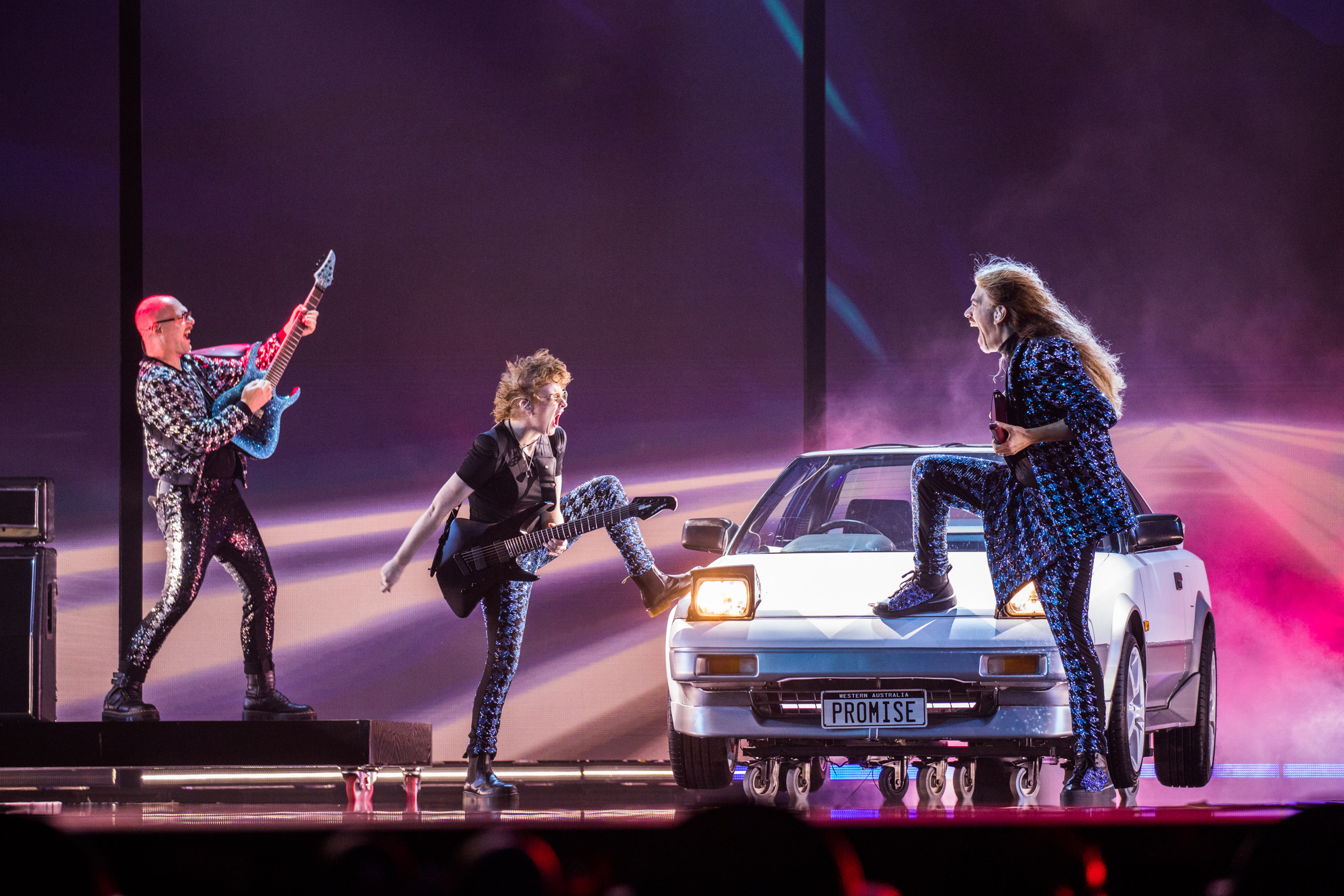 Three performers on stage with a car at Eurovision 2023. Shot by Corinne Cumming with the Canon EOS R5.