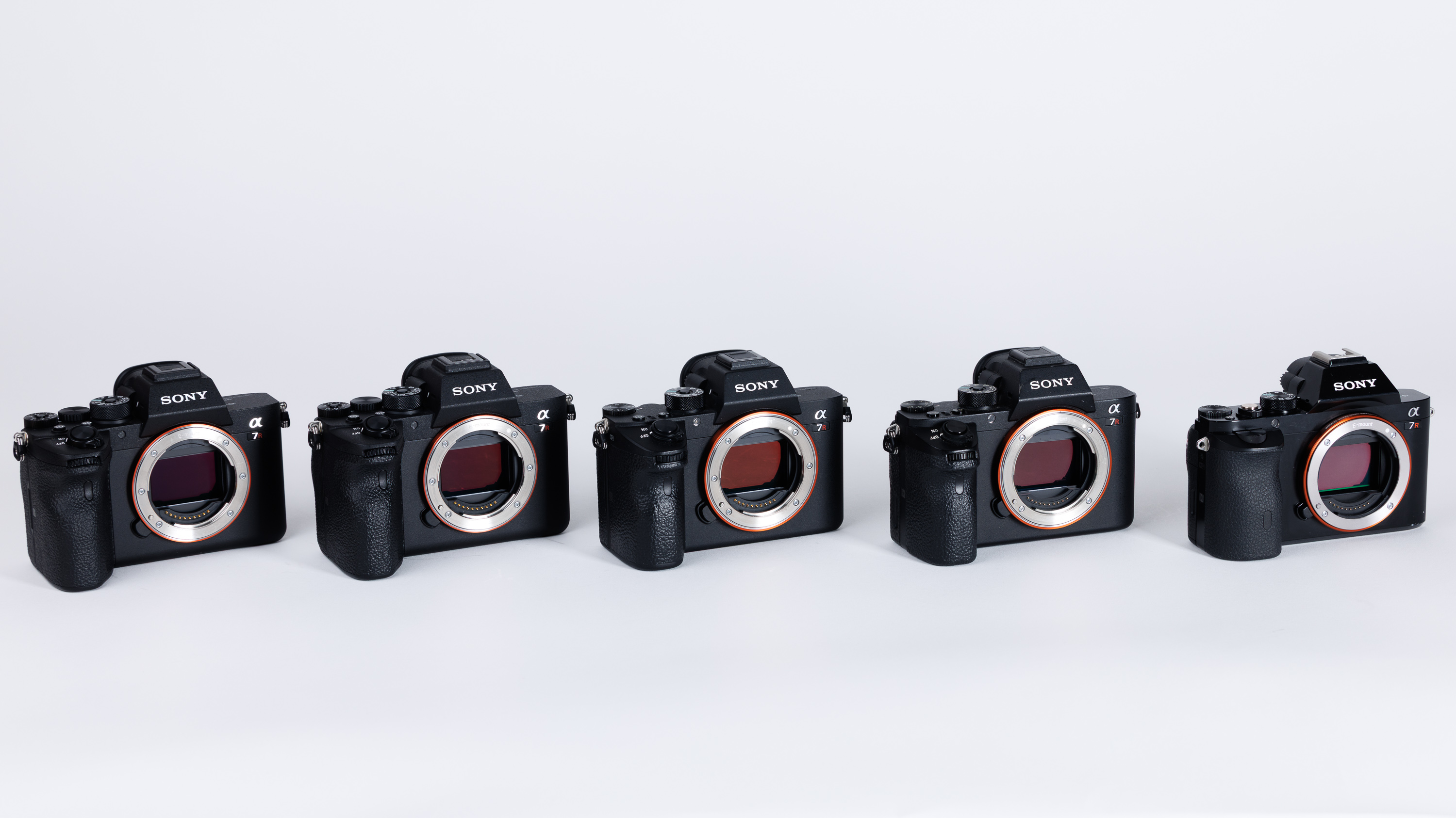 Each camera from the Sony A7R series on a white background. From L-R: Sony A7R V, Sony A7R IV, Sony A7R III, Sony A7R II, Sony A7R