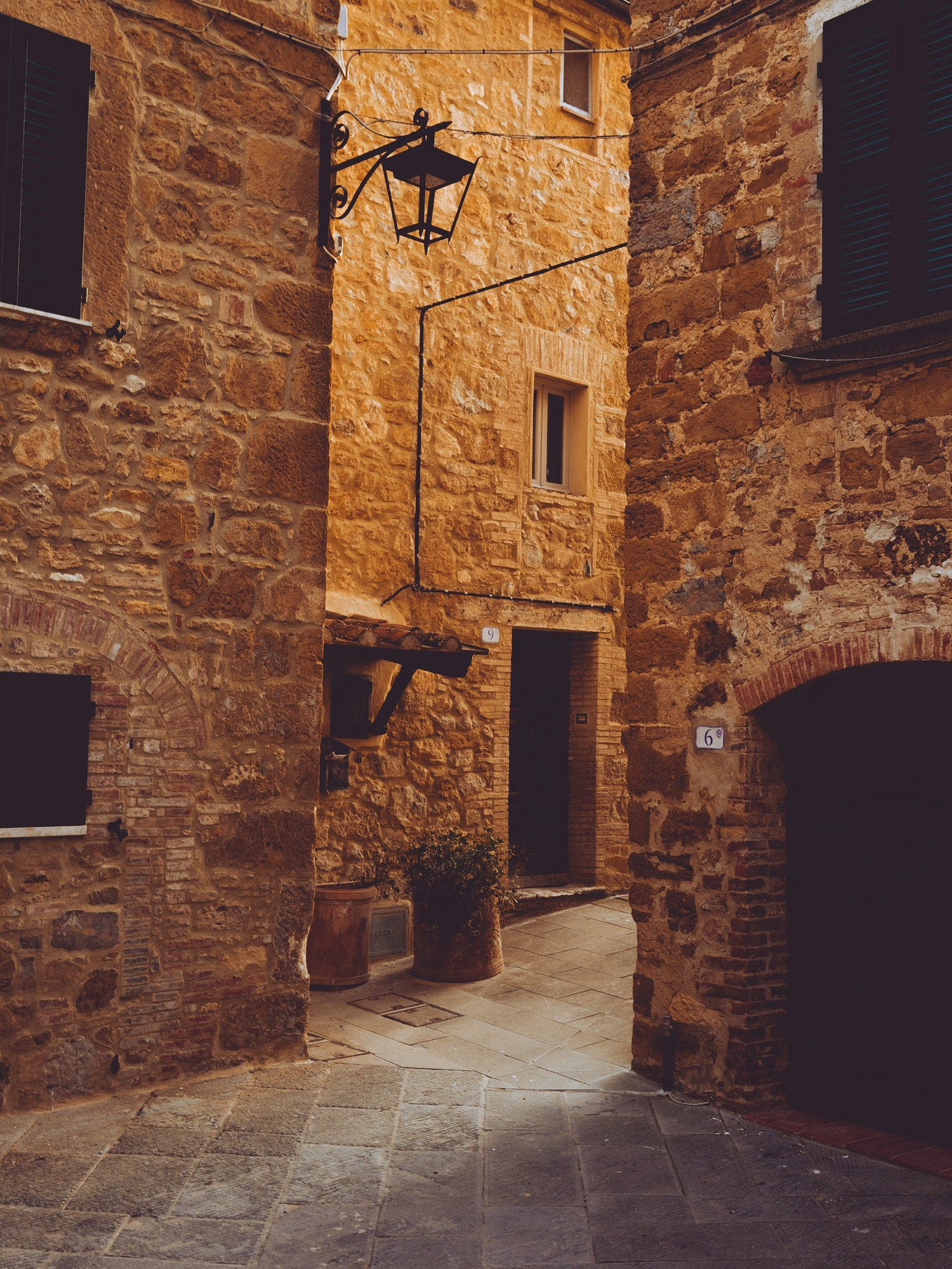 A street in Petrolo, Tuscany. The buildings have arched windows and doors in them.