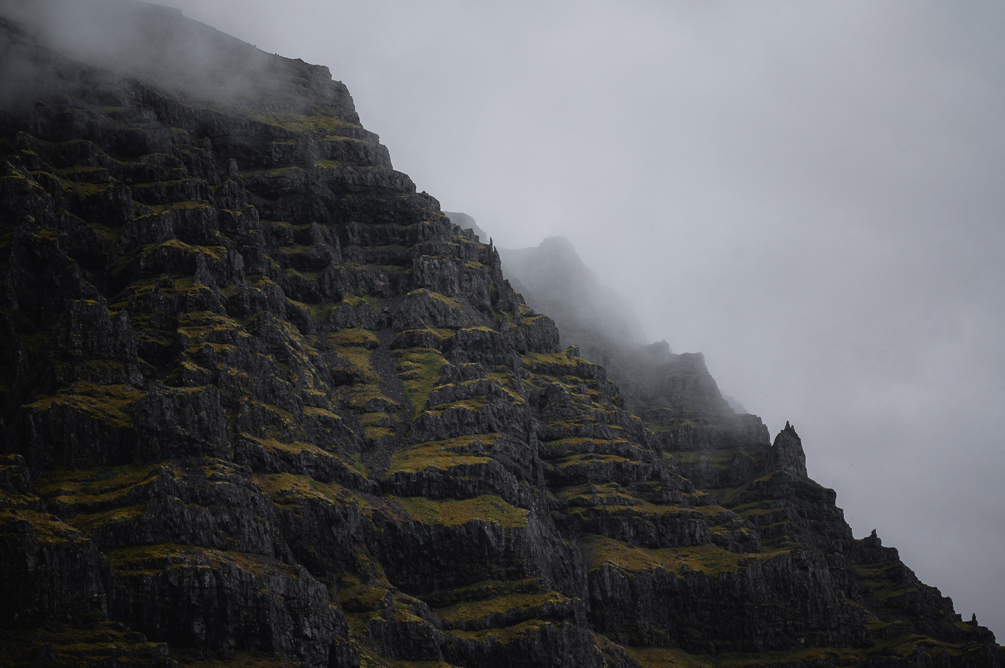 A hillside covered in clouds in Iceland, with edges of the hill covered in moss, shot by Paul Watson with a Nikon Z6
