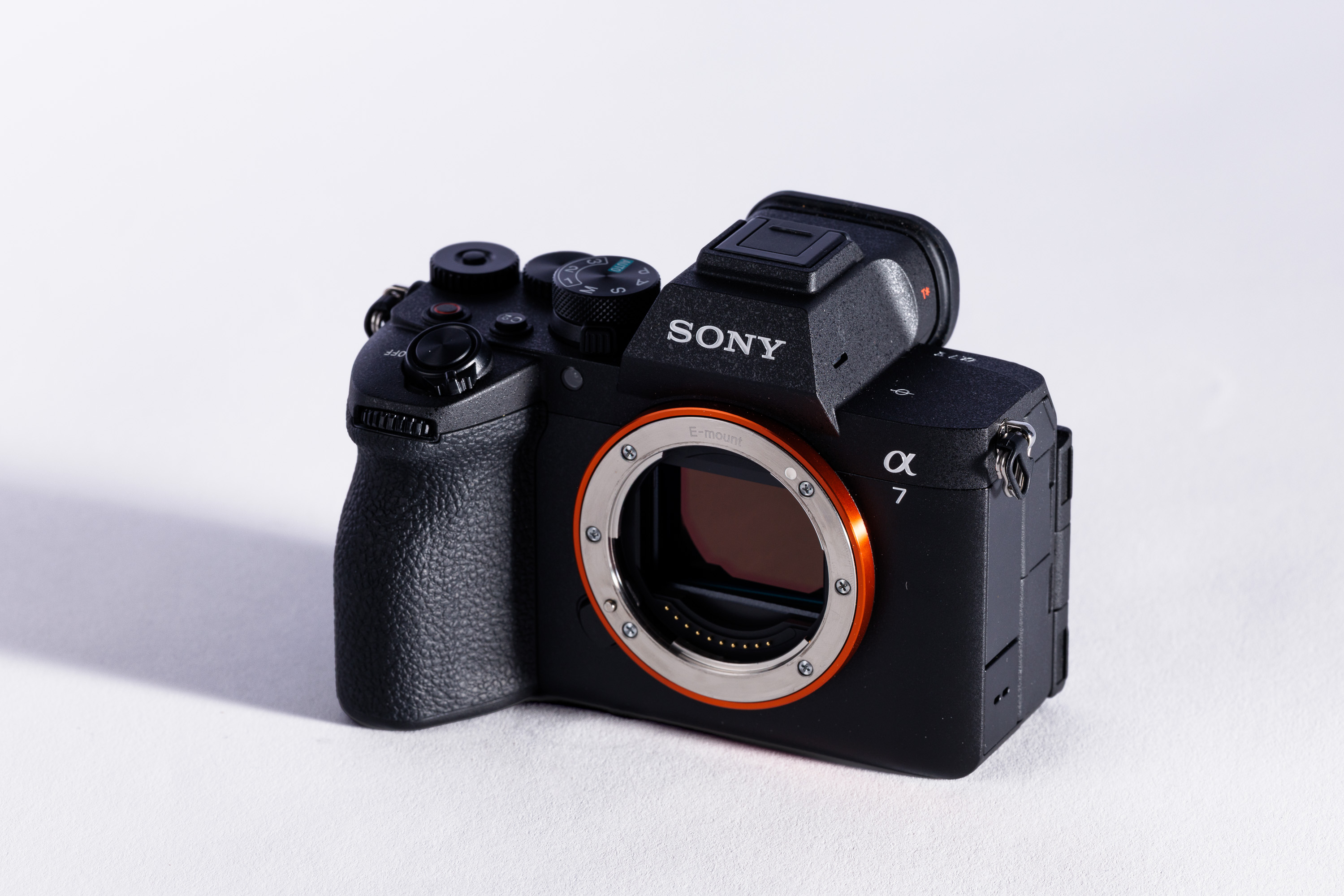 A used Sony A7 V body on a white background, with a shadow to the left.