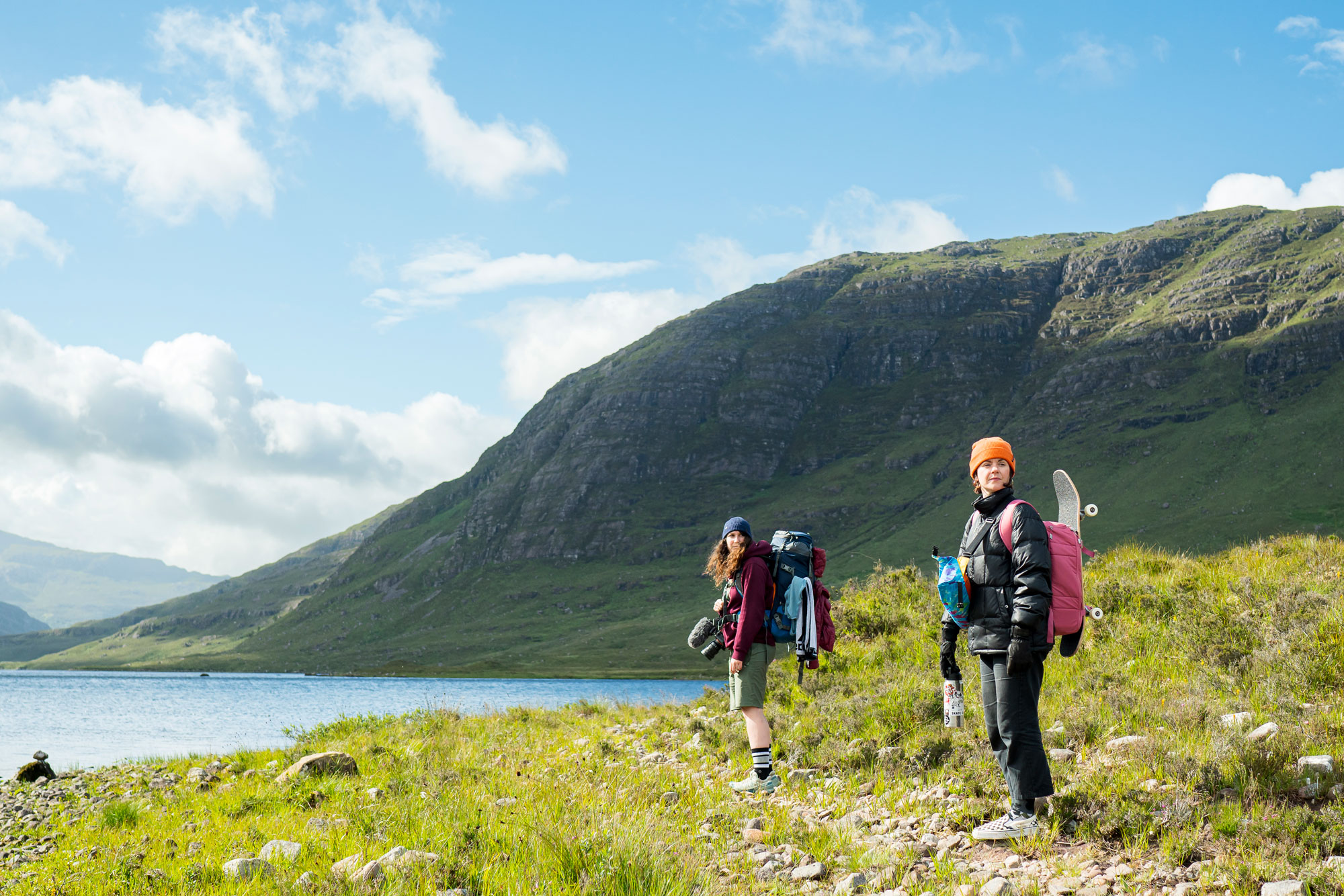 Two skateboarders, Hannah Bailey and Lyndsay McLaren, in the Scottish Highlands