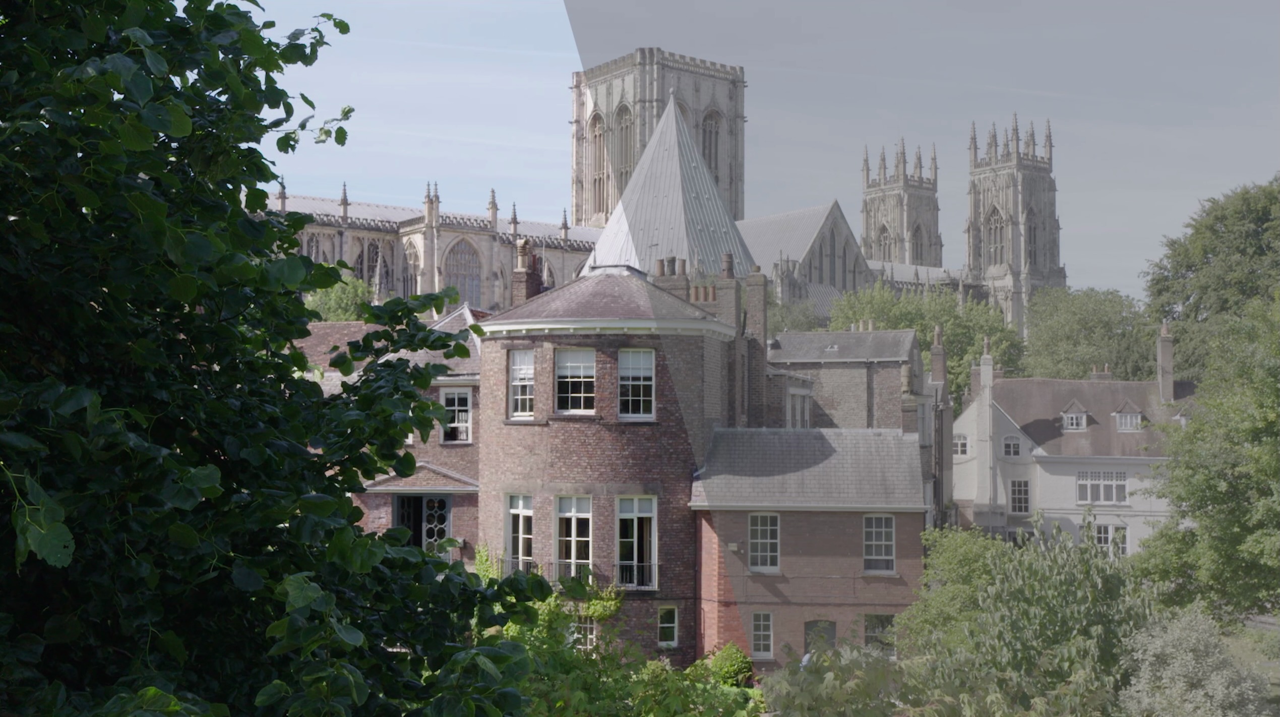 A side-by-side comparison image of York Minster showing the difference between S-Log footage with and without colour grading