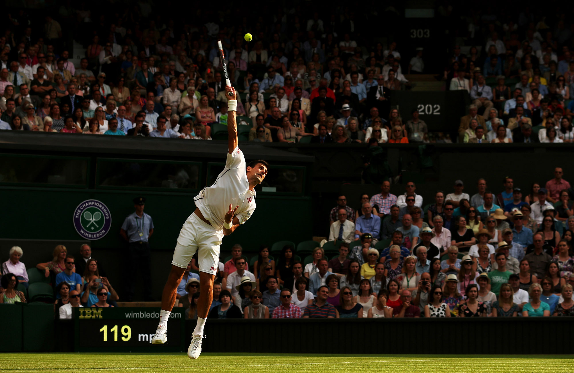 Novak Djokovic of Serbia serves the ball to Andrey Golubev of Kazakhstan at Wimbledon on June 23, 2014 in London, England