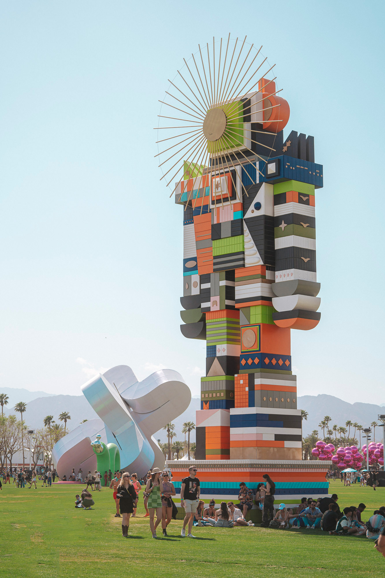 Bright-colored sculpture in a field at 2023 Coachella Valley Music and Arts Festival.