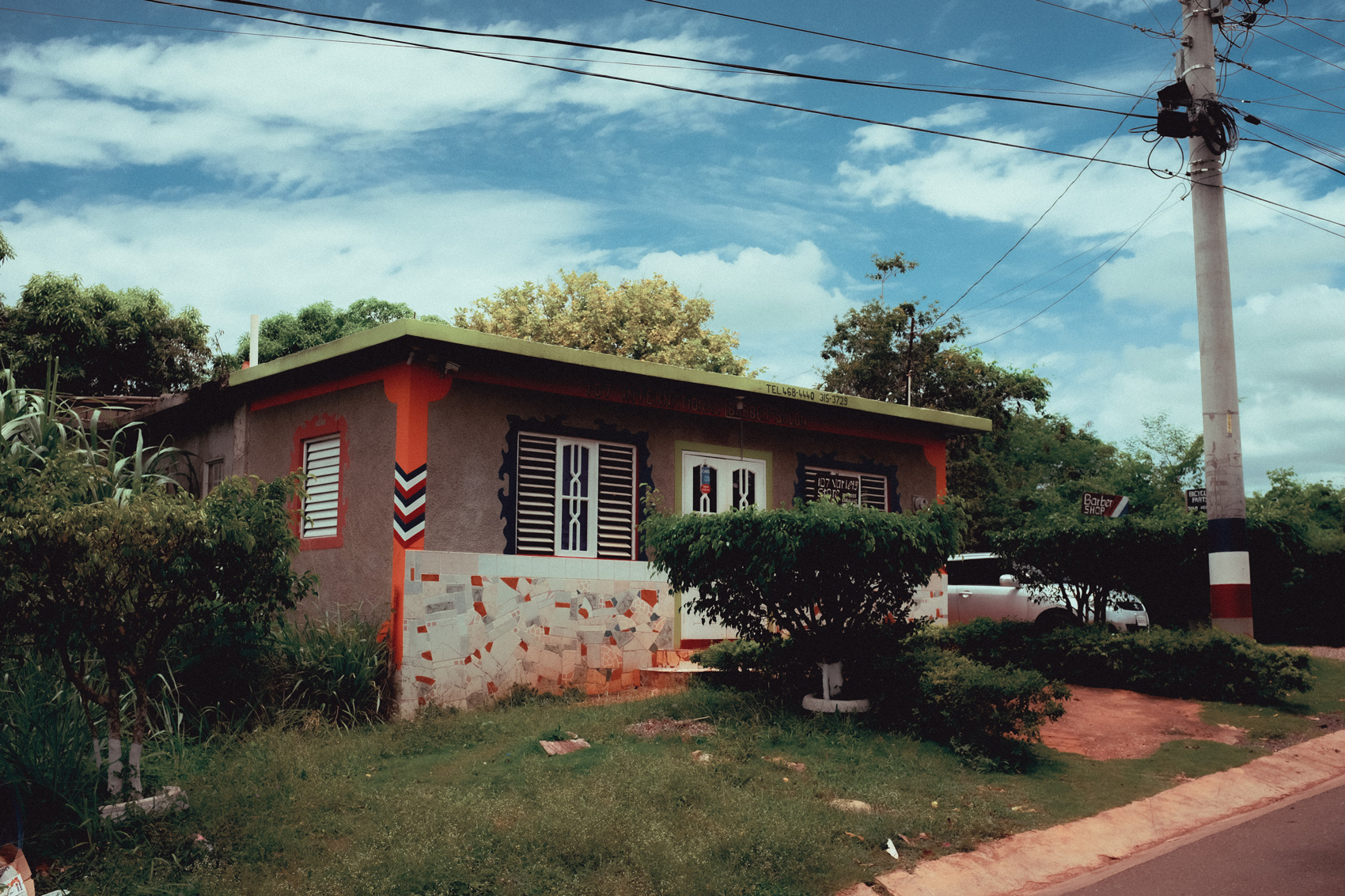 A single-story house with orange siding in Jamaica