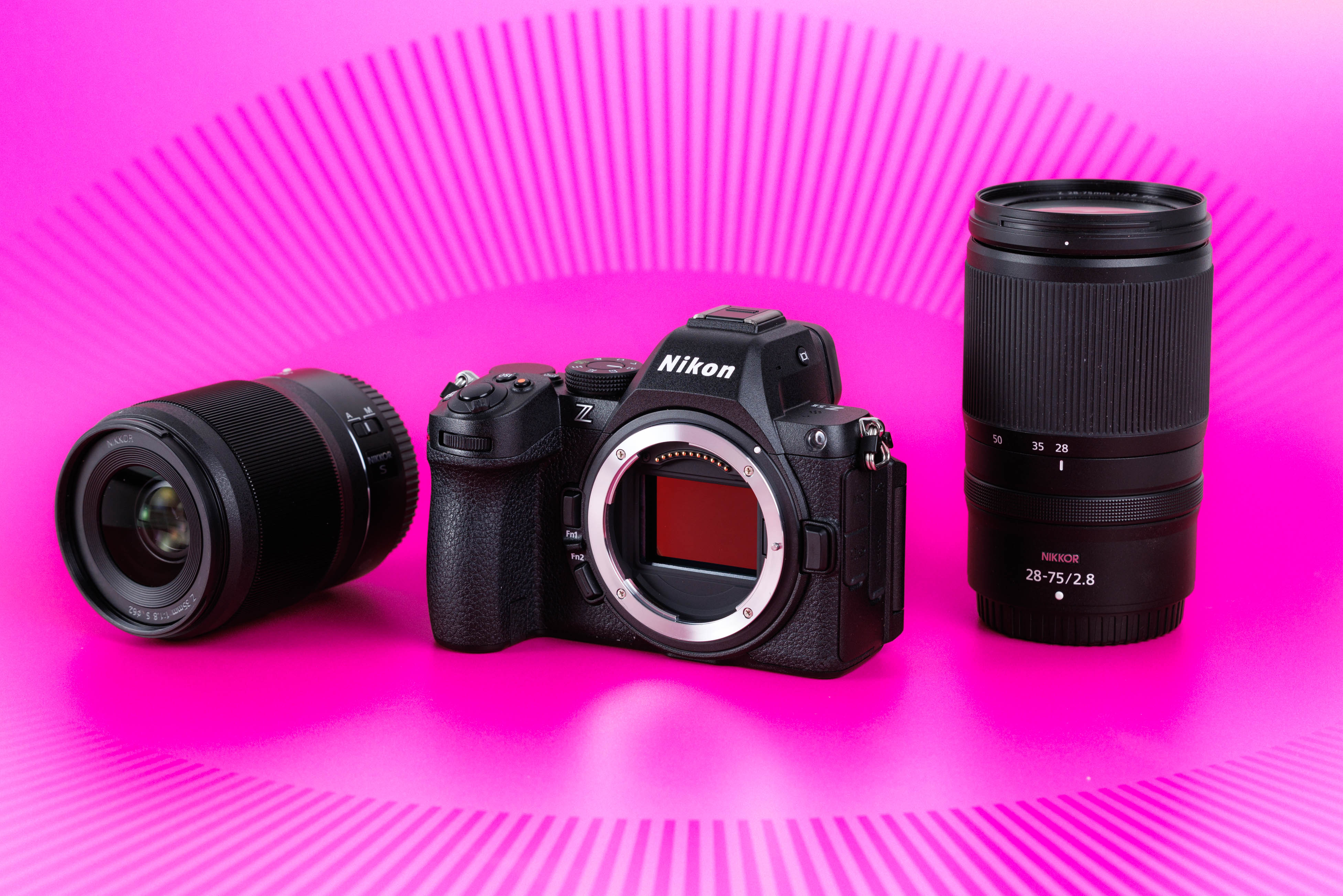 Nikon Z5 II full-frame mirrorless camera (body only) with two NIKKOR Z lenses against a pink studio background