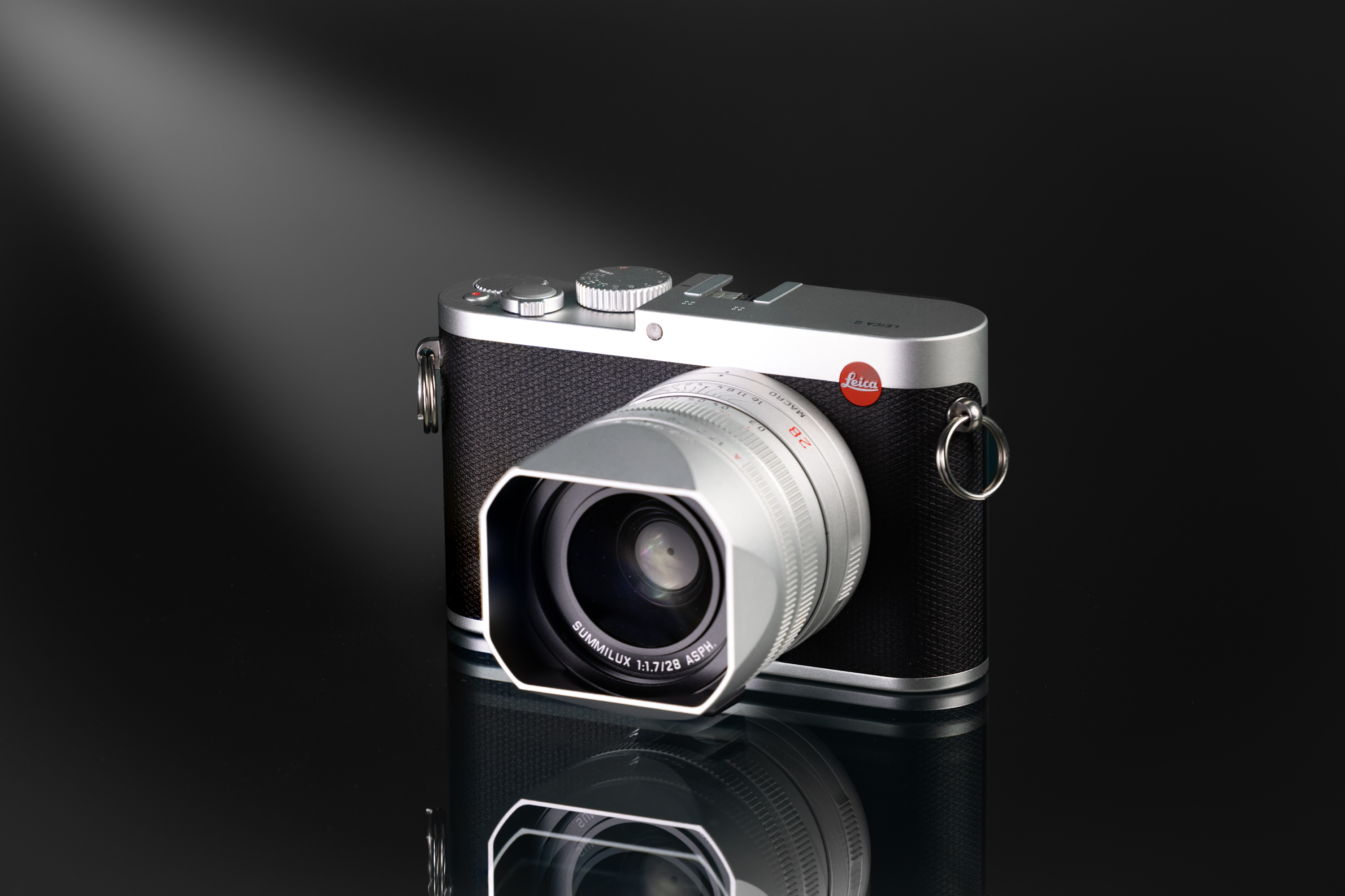 Used Silver Leica Q on a black and white background
