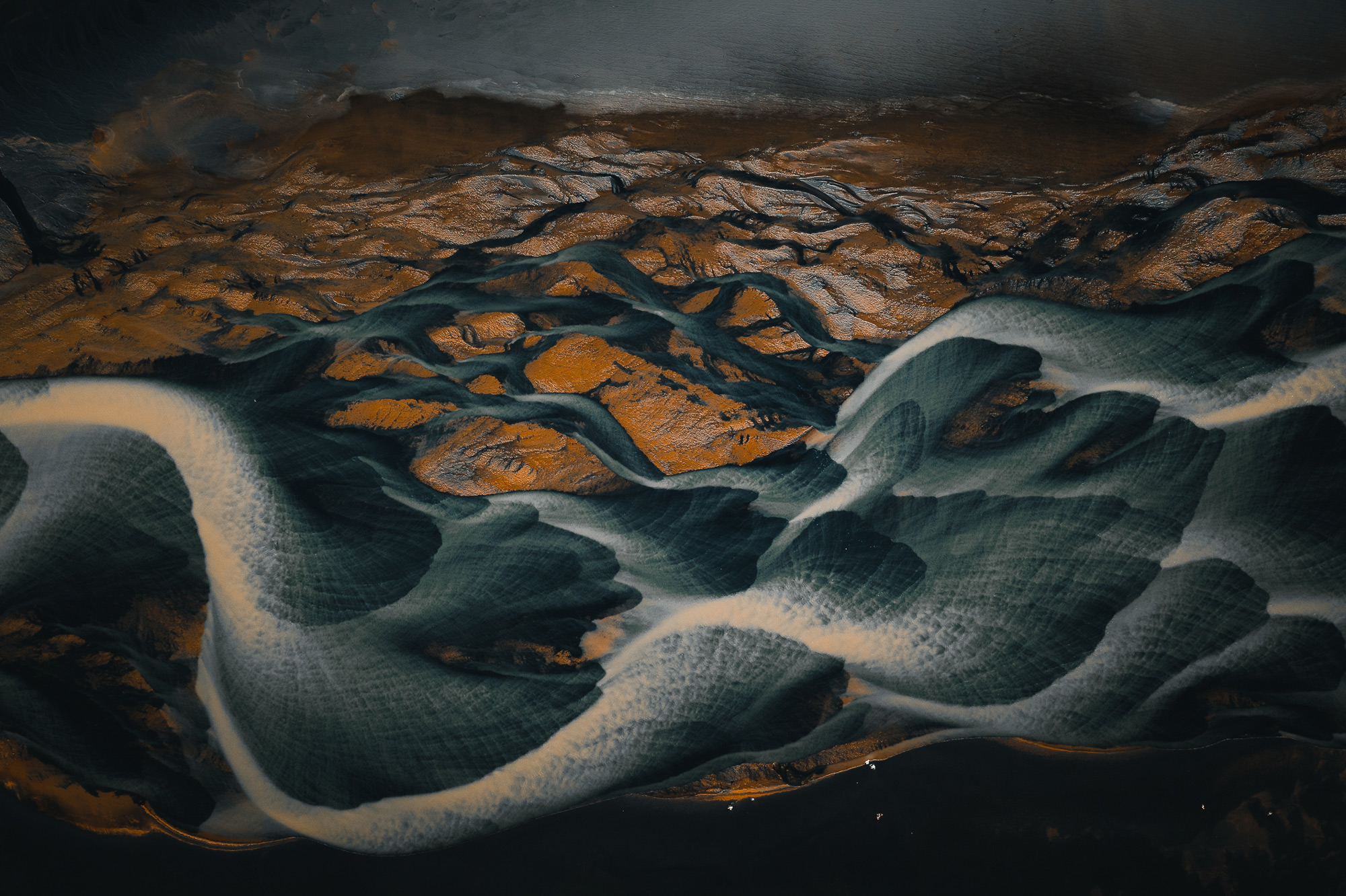 An aerial drone abstract painting-like photo of blue-and-white rivers running through a valley in Iceland, shot by Paul Watson with a DJI Mavic 2 Pro