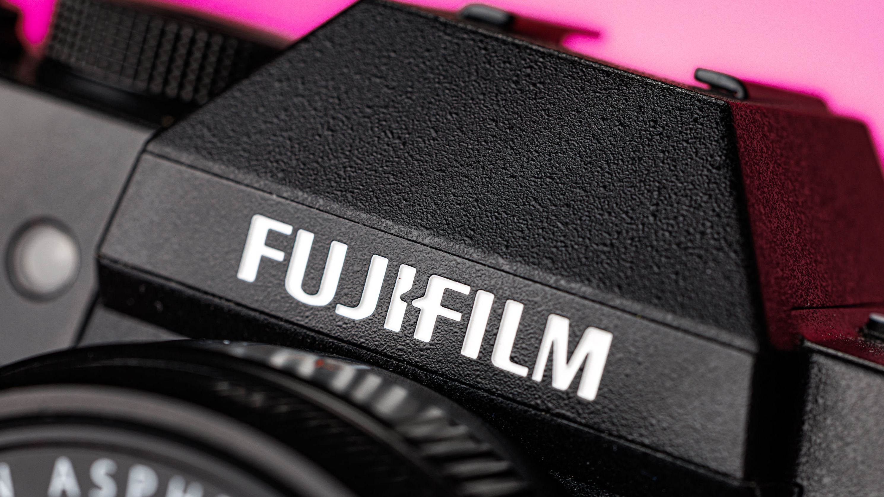 Close-up of the ‘Fujifilm’ logo on a Fujifilm camera 

