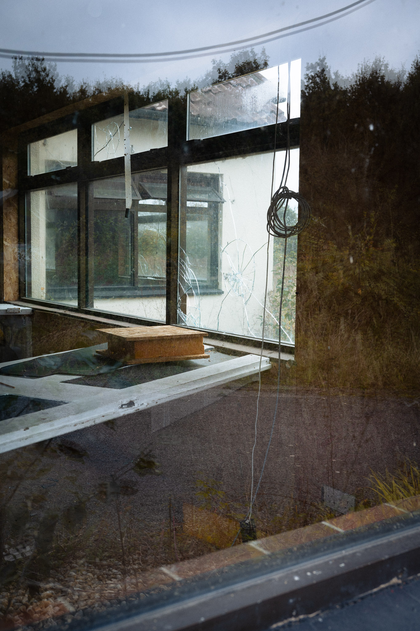 Cracked window panes in an abandoned house, photographed with the Nikon Zf by Jakub Golis.
