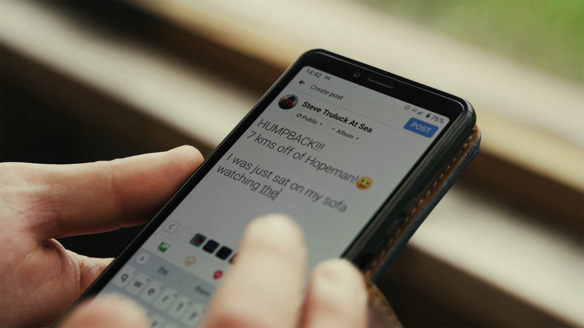 Steve Truluck on his phone posting on social media about spotting a humpback whale, a still taken from the short film Truluck by Matt Cannon and Jake Smallwood
