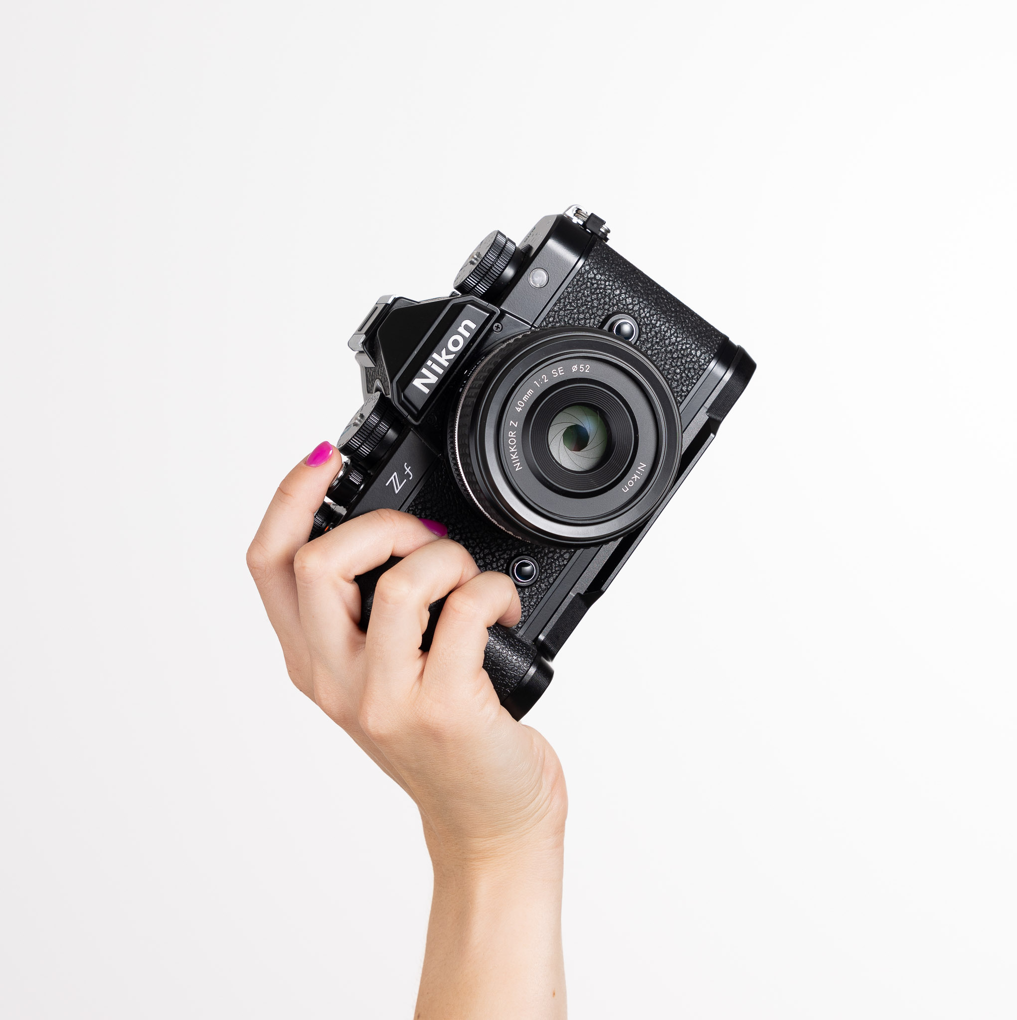 A hand holding the Nikon Zf up 