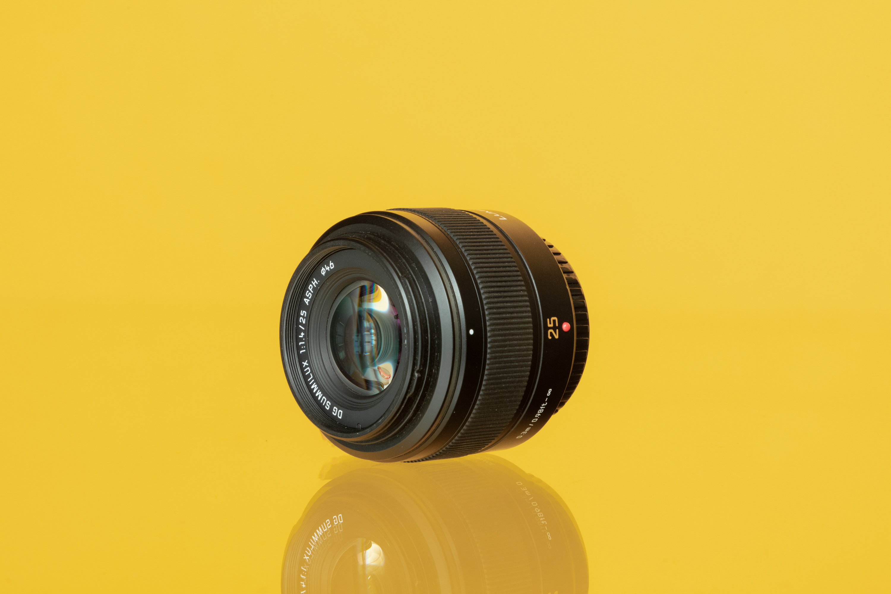 Used Sony FE 35mm f/1.8 from MPB on a yellow background