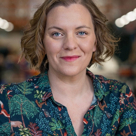 A portrait photo of Sophie Collins wearing a dark flowery top