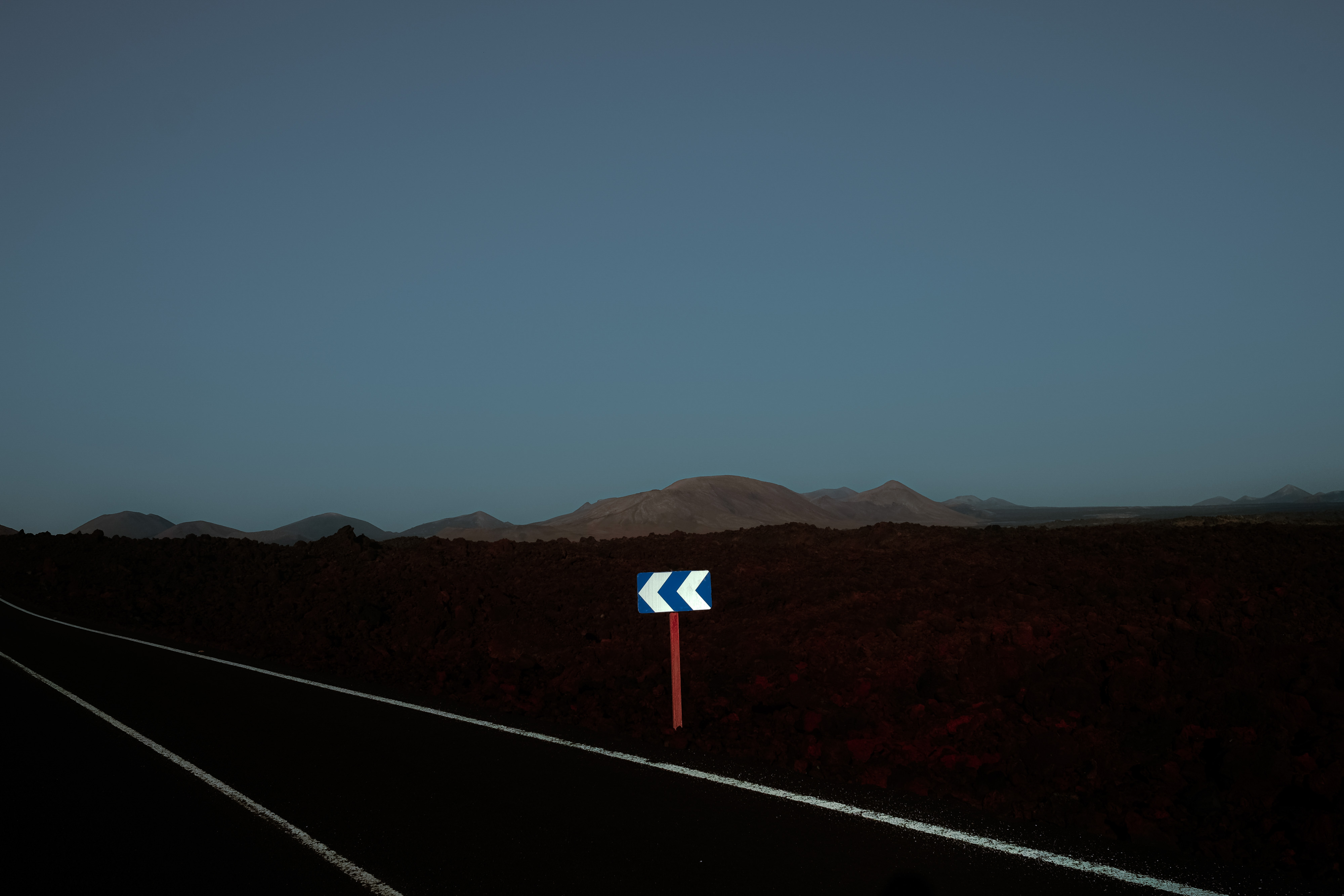 An infrared photo of an arrows road sign at night in Lanzarote, shot by Ian Howorth with an IR-Converted Fujifilm X-T1