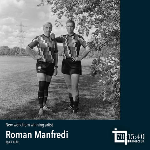 Black-and-white photo of two football/soccer players, one with their arm on the other, photo by Roman Manfredi