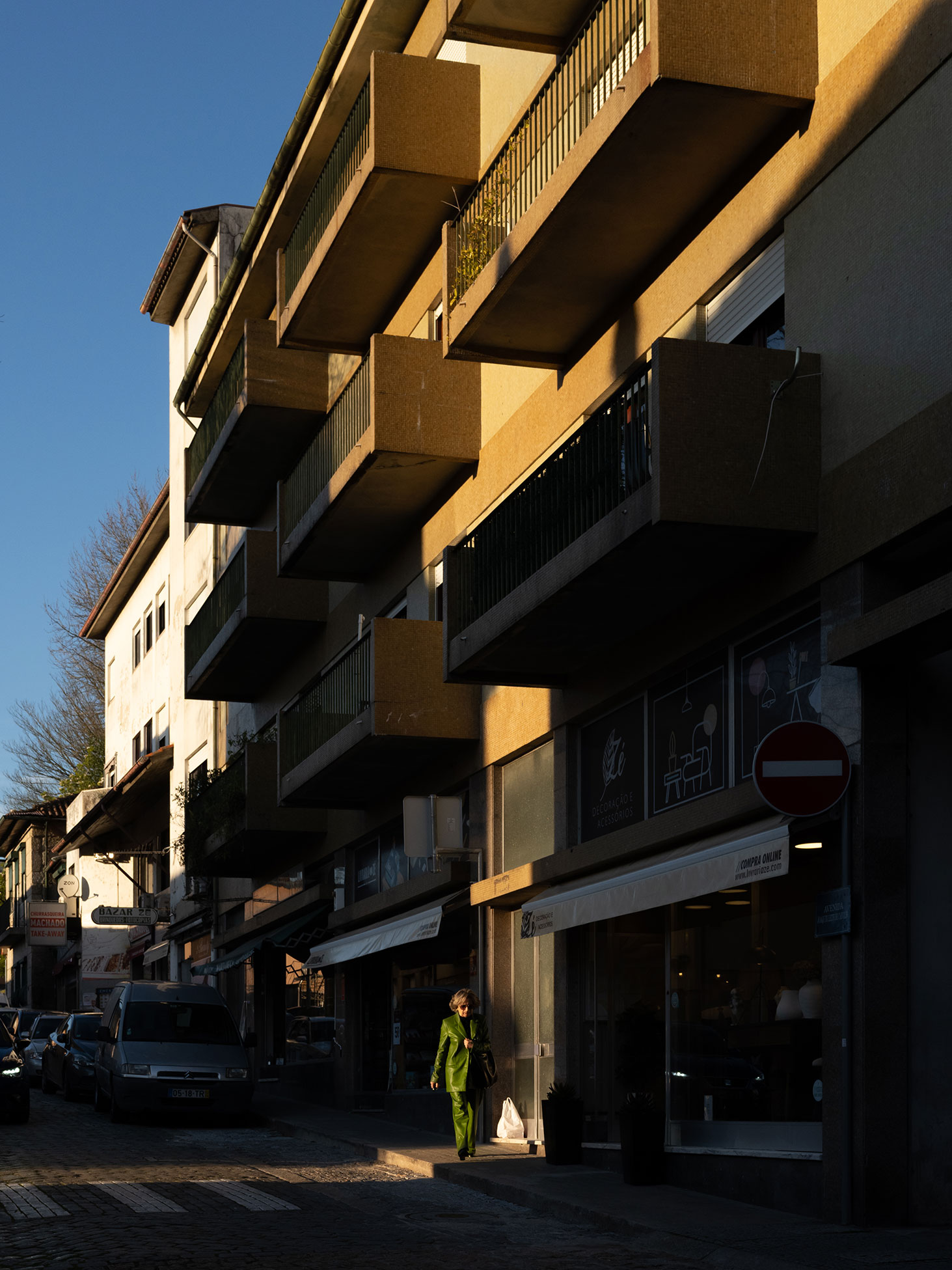Apartment buildings half in shadow im Porto, Portugal. Shot on the Fujifilm GFX100RF by Amy Moore.