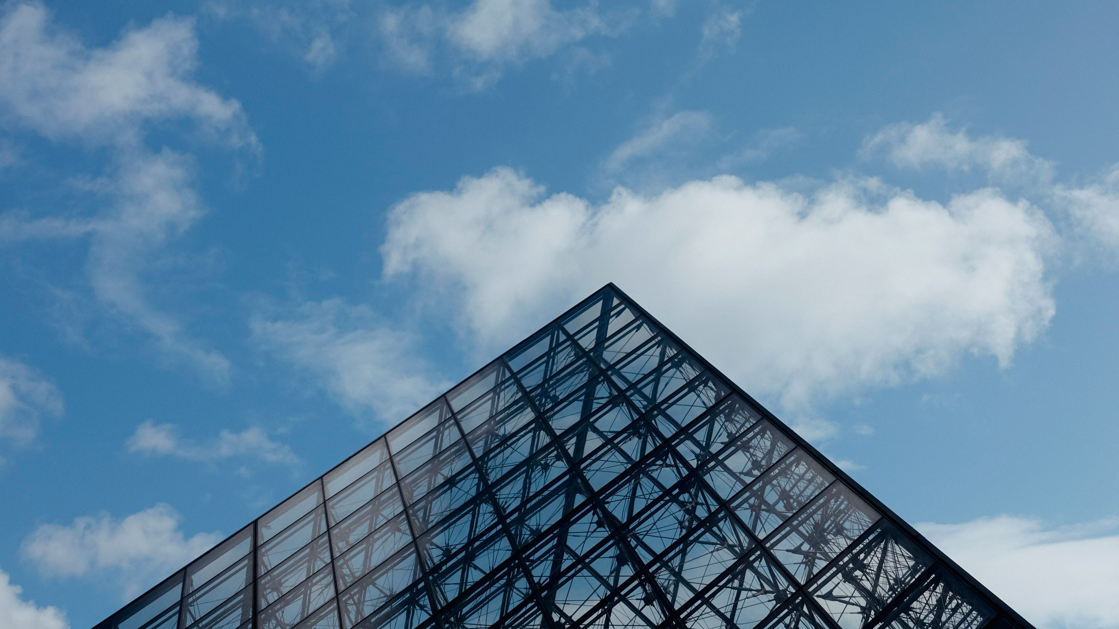 Top of the Louvre pyramid in Paris, France, on a sunny, blue sky day in March. Photo taken on a Sony RX100 IV by Kristi Townsend.
