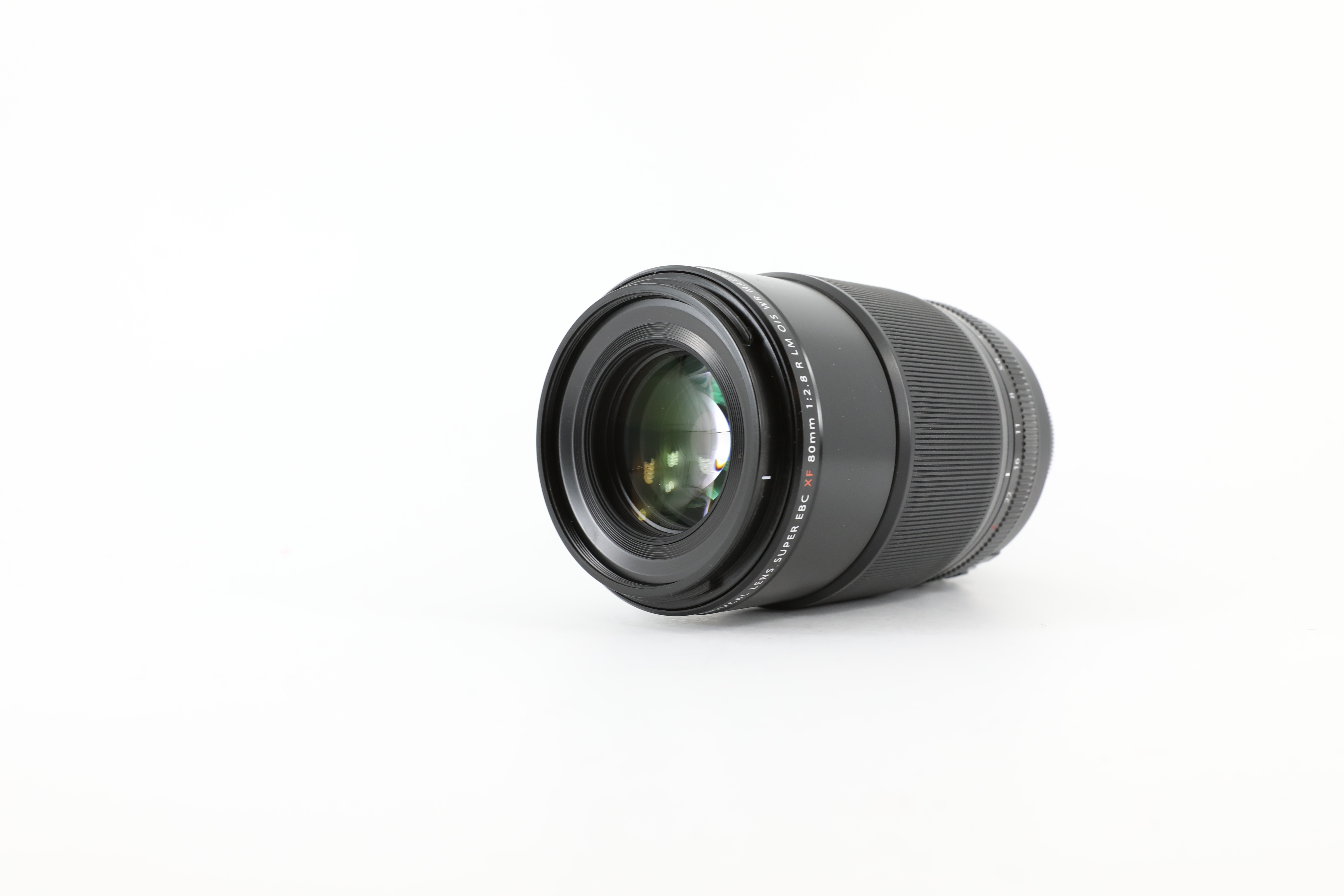 Image of the Fujifilm XF 80mm f/2.8 R Macro lens on a white background.