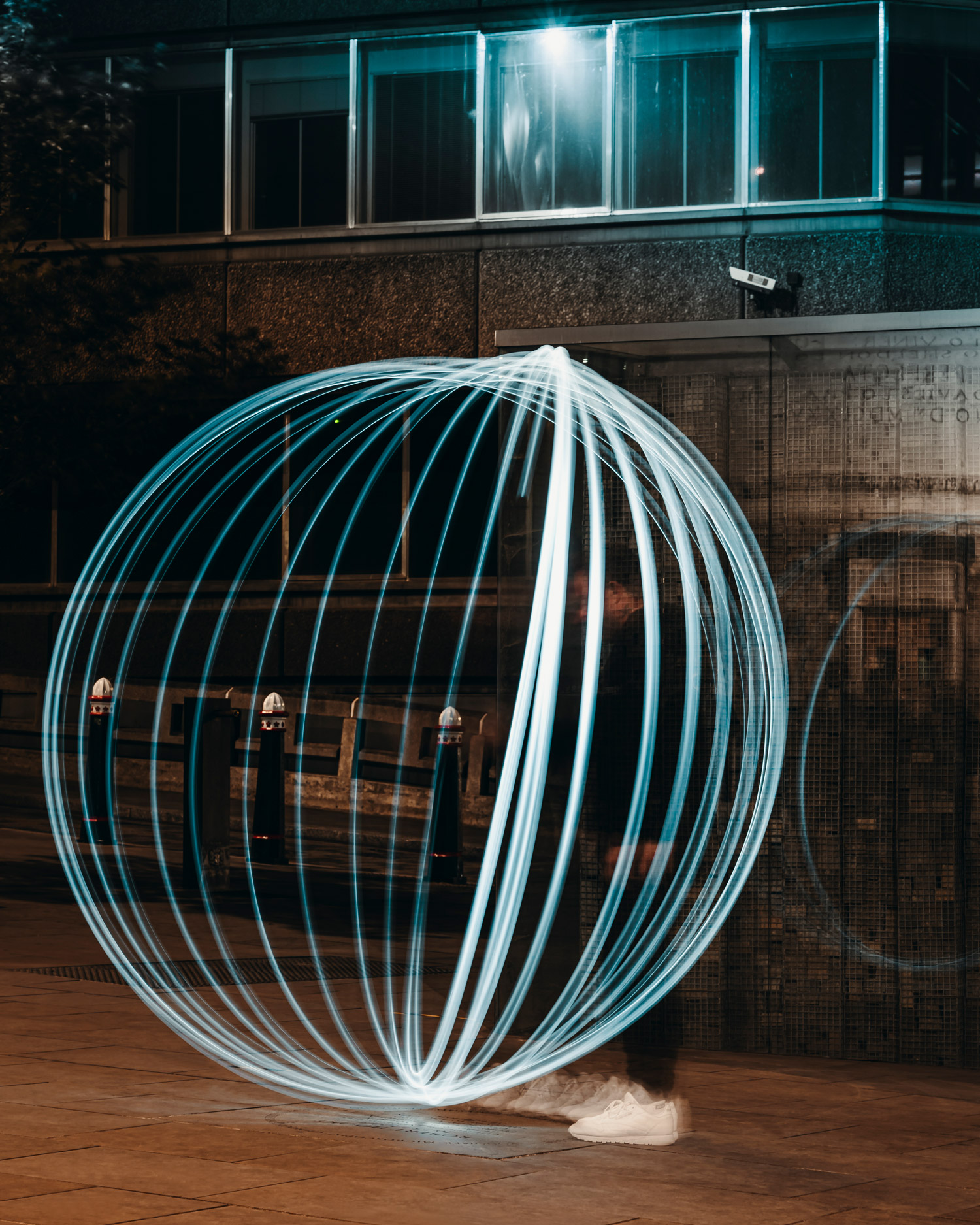 A performer moves a torch to create a circle of lines, photo created using the light painting technique.