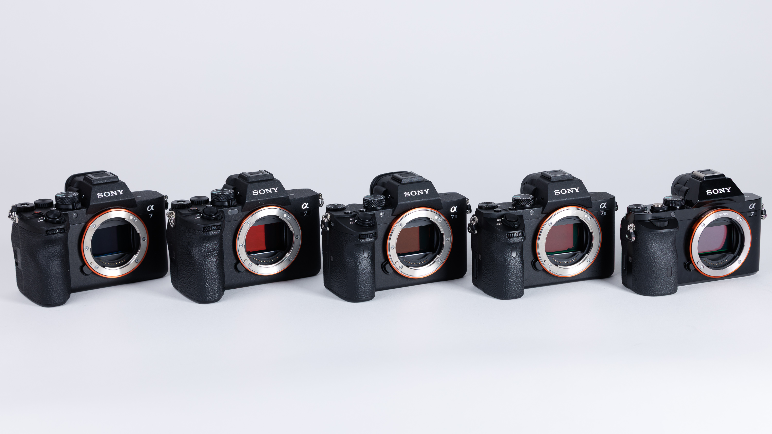 Used Sony A7 bodies on a white background. From L-R: Sony A7 V, Sony A7 IV, Sony A7 III, Sony A7 II, Sony A7 