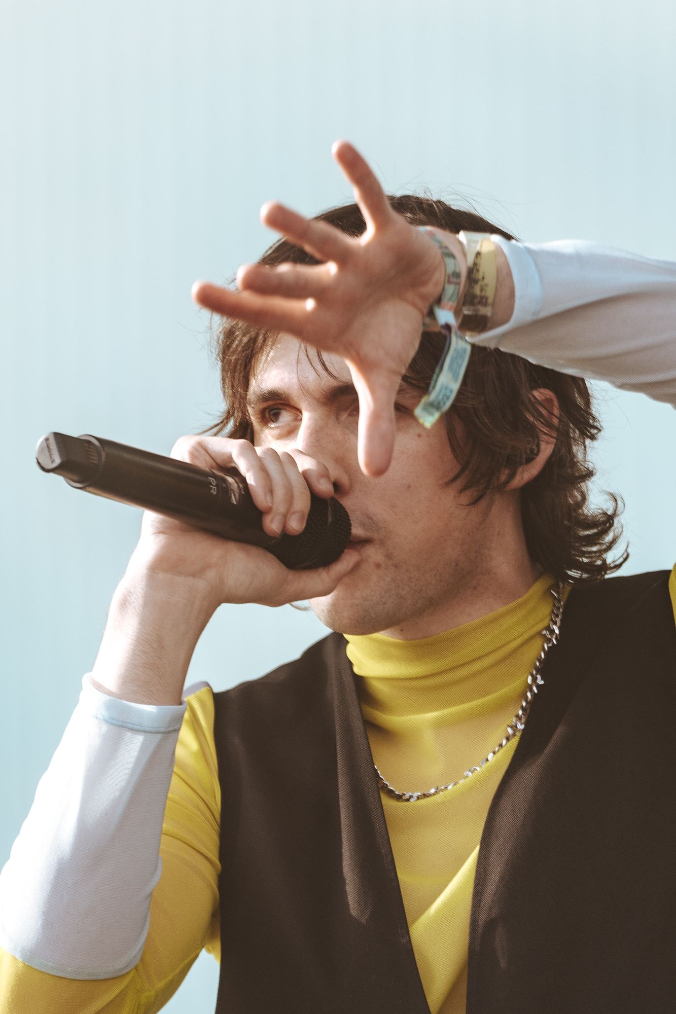 Porter Robinson on-stage singing into a microphone at 2023 Coachella Valley Music and Arts Festival.
