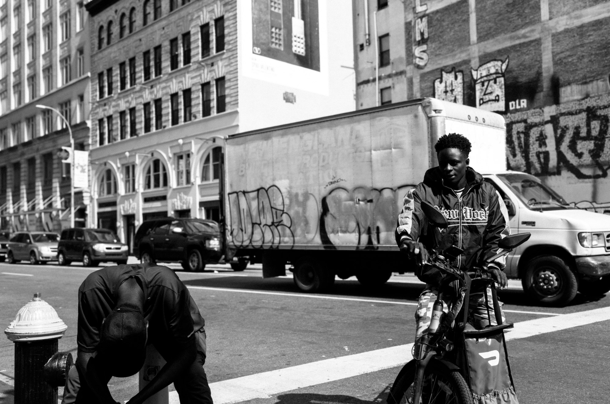 A black-and-white photo of two people on a New York City street