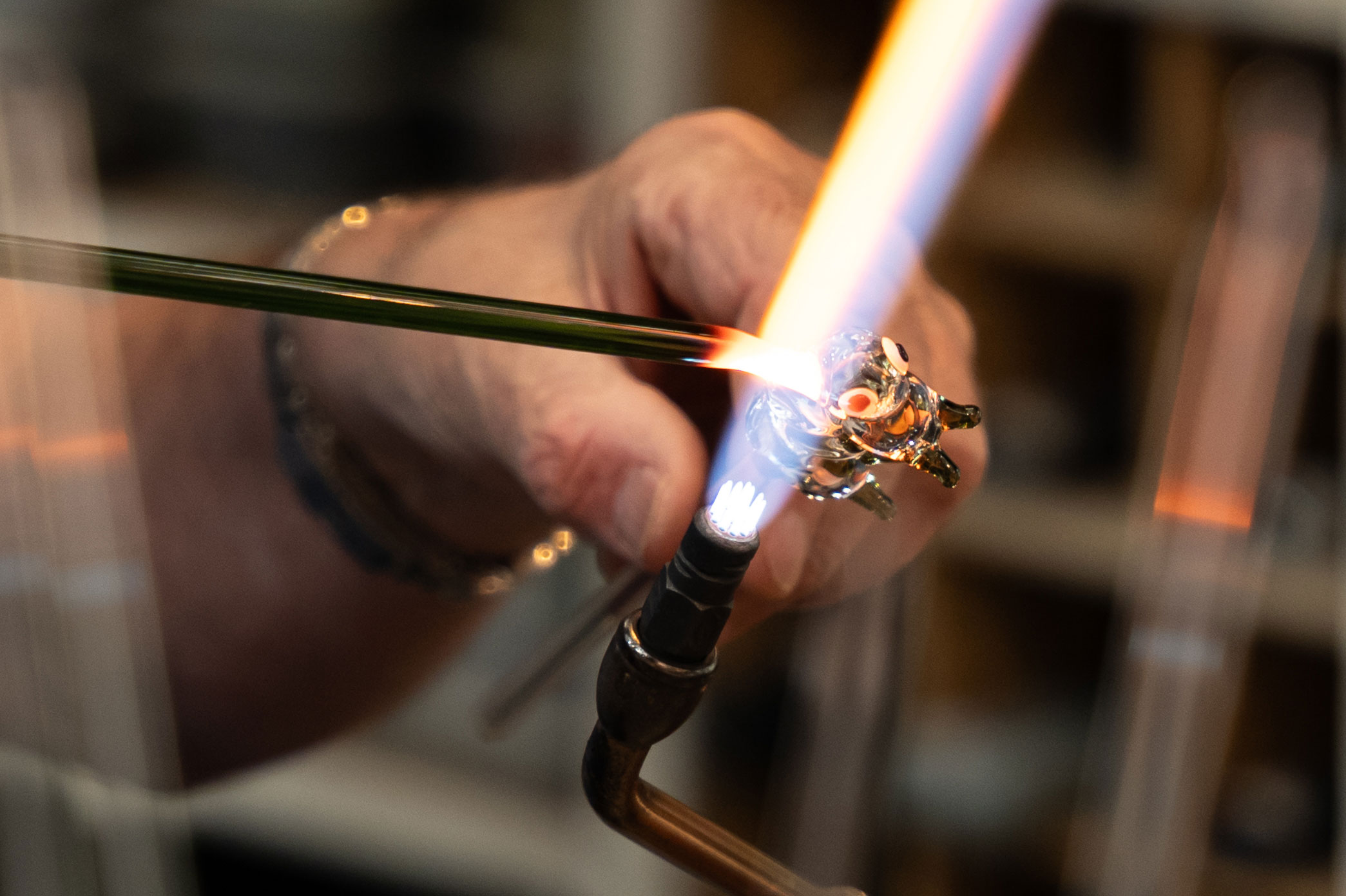 A close up of a glass figurine being worked on with a torch. Photo by Amy Moore with the Panasonic S1R II.