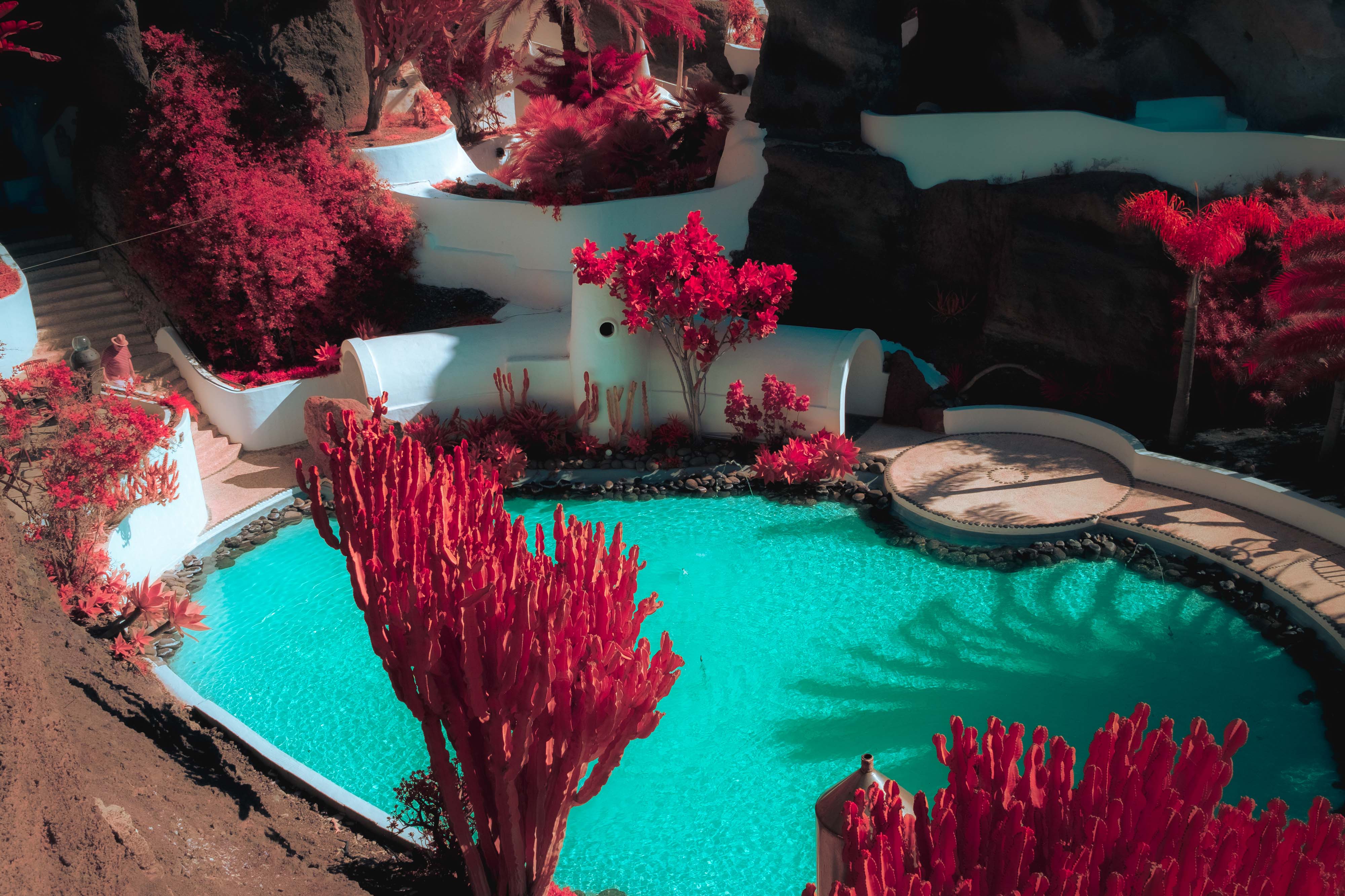 An infrared photo of a swimming pool surrounded by flora in Lanzarote, shot by Ian Howorth with an IR-Converted Fujifilm X-T1