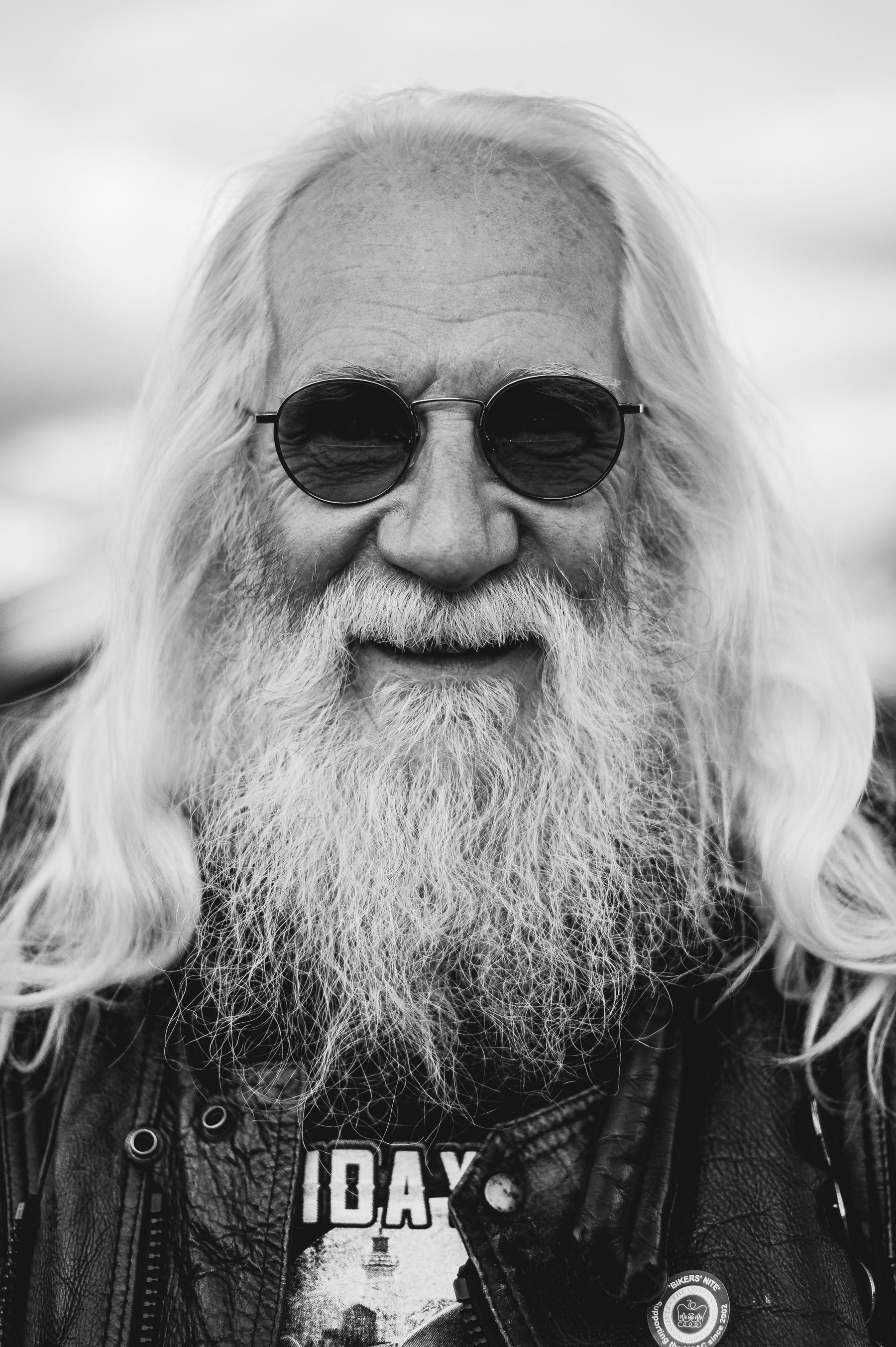 Black-and-white photo of an older person wearing sunglasses