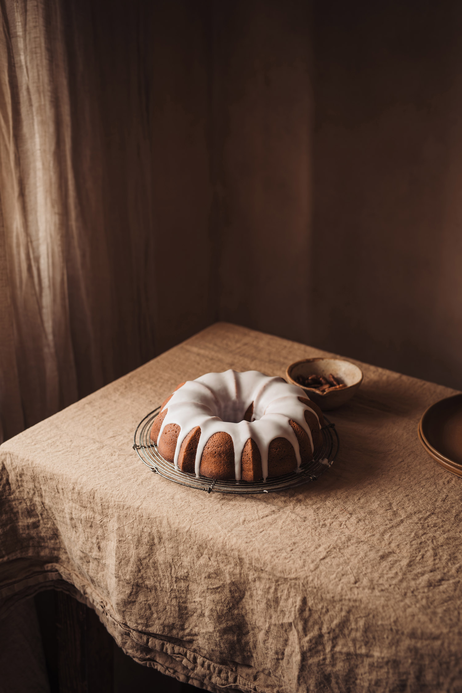 A cake covered with icing on a table, shot by Bea Lubas with the Canon EOS 5D Mark IV.


